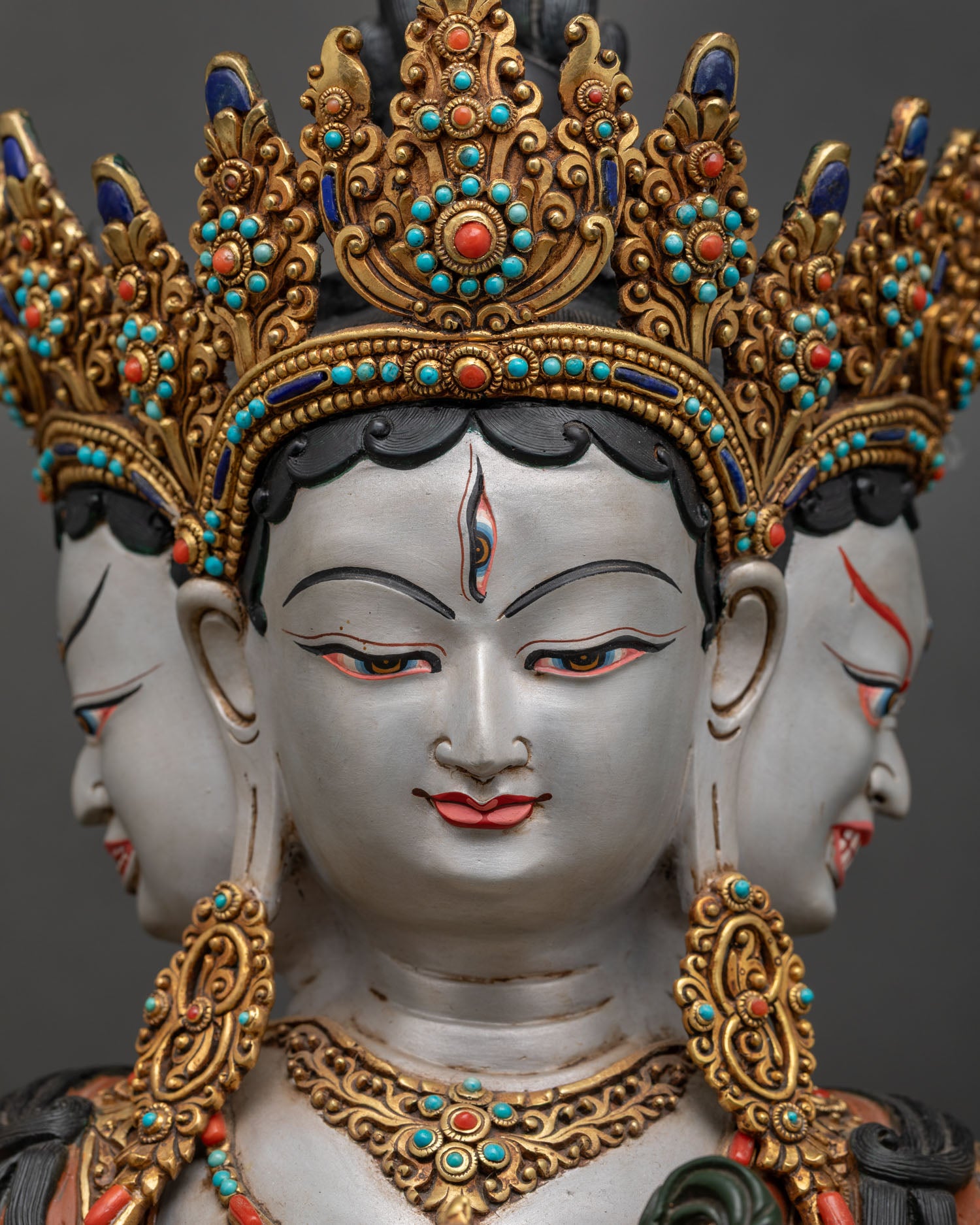 detailed close up of namgyalma three serene faces with gold gilded crown and acrylic painting