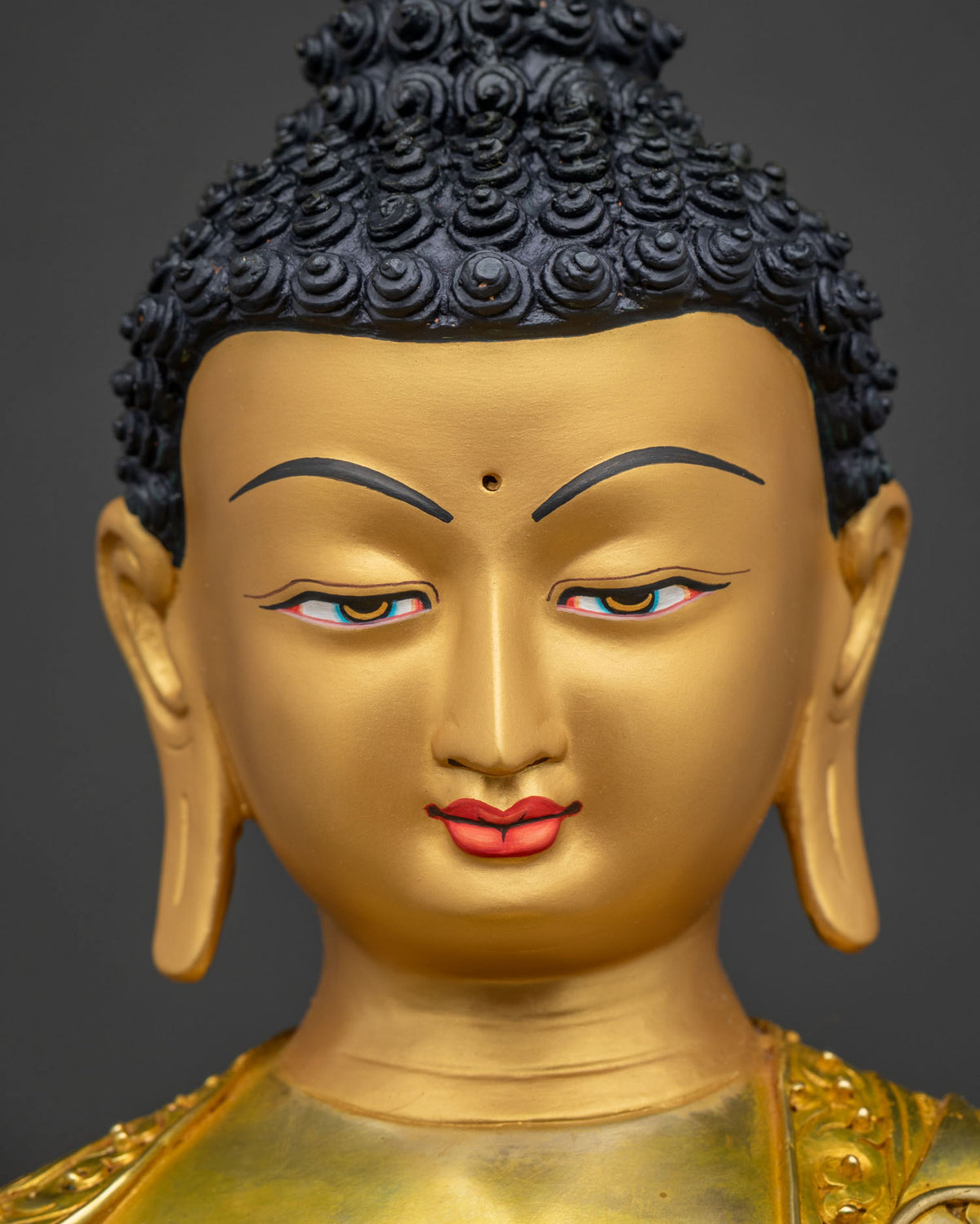 Detailed close-up of Shakyamuni Buddha's gold-painted face, serene expression, Nepal