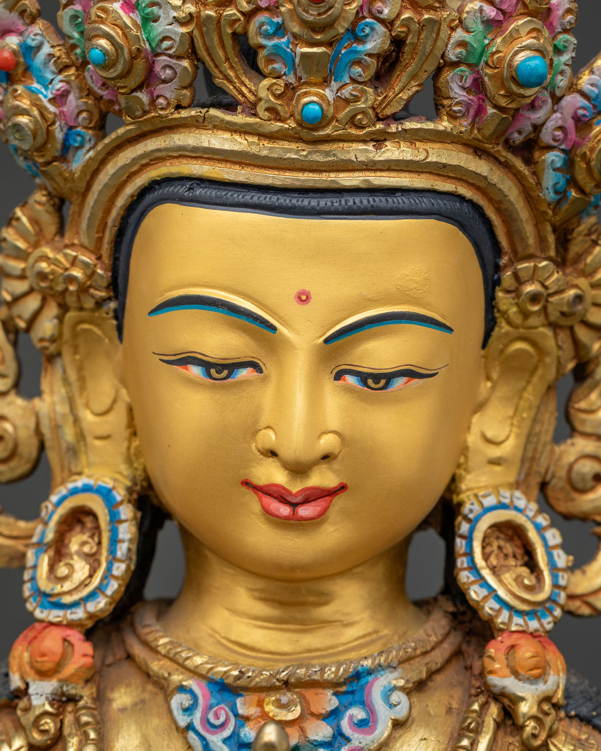Detailed close up of Vajrasattva face, 24K gold painted serene expression on handcrafted Nepal statue