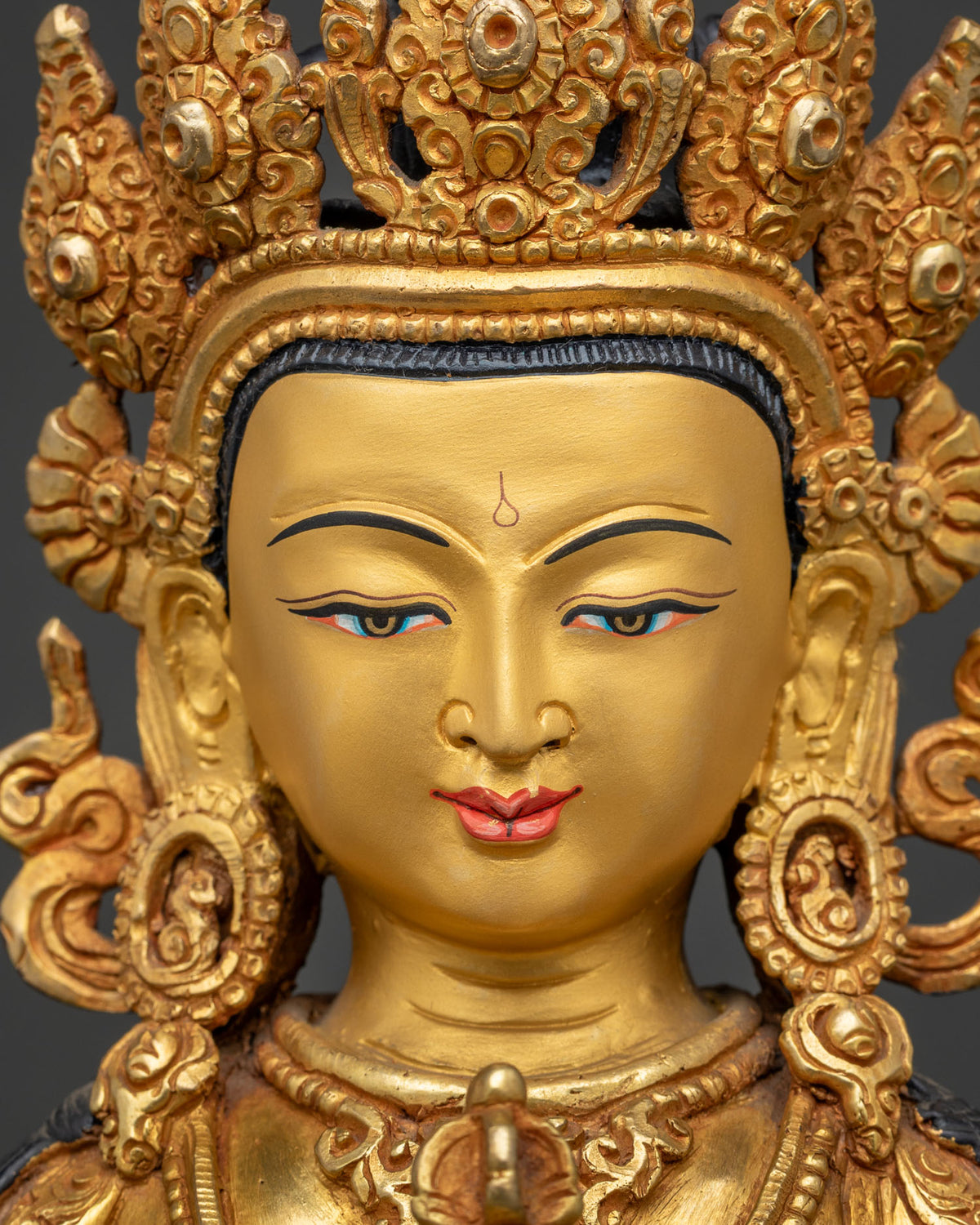 Detailed close up of Vajrasattva face with serene expression and Five-Jeweled Crown, gold gilded copper