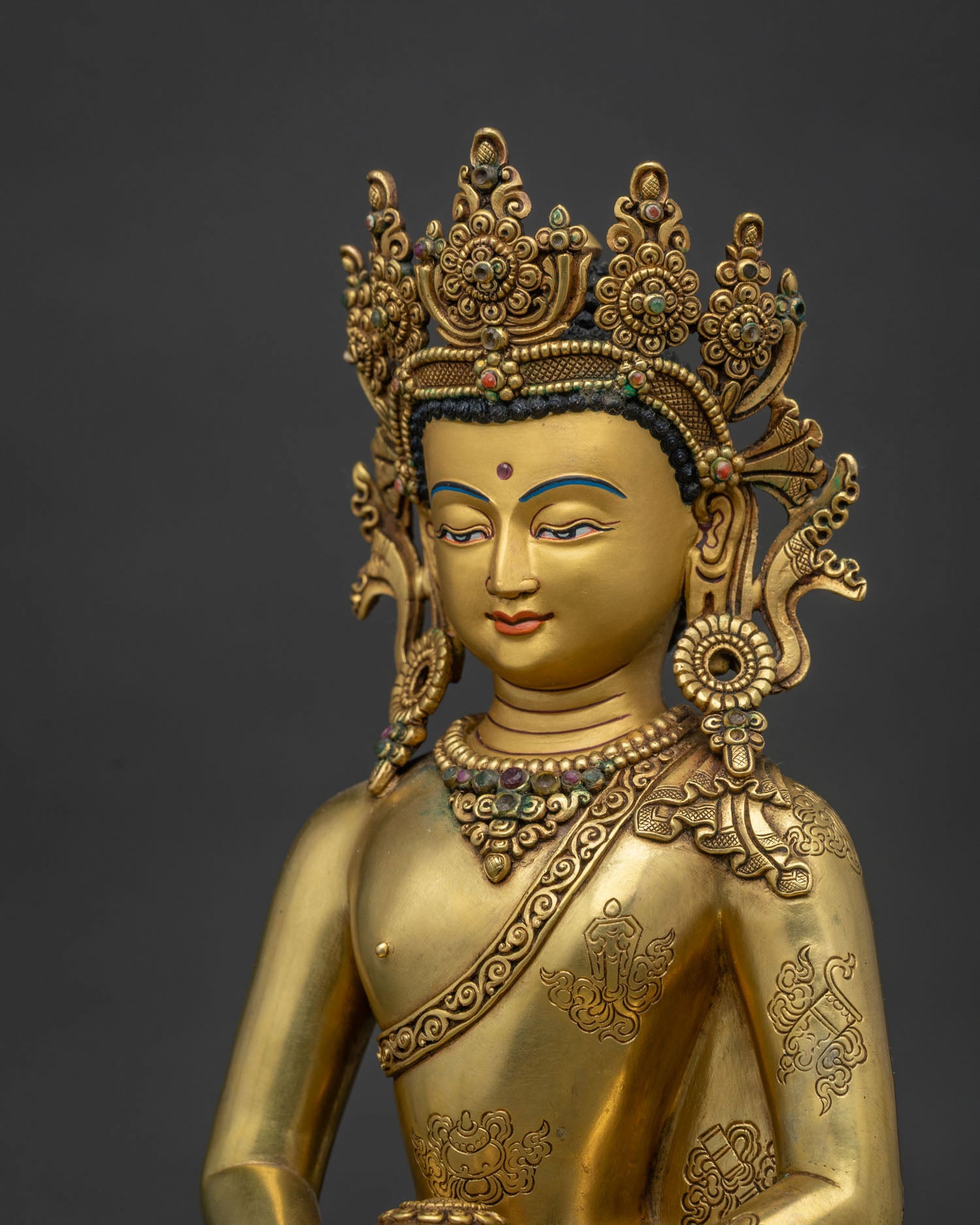 Detailed face close up of Amitabha Buddha with serene gold painted features and semi precious stones