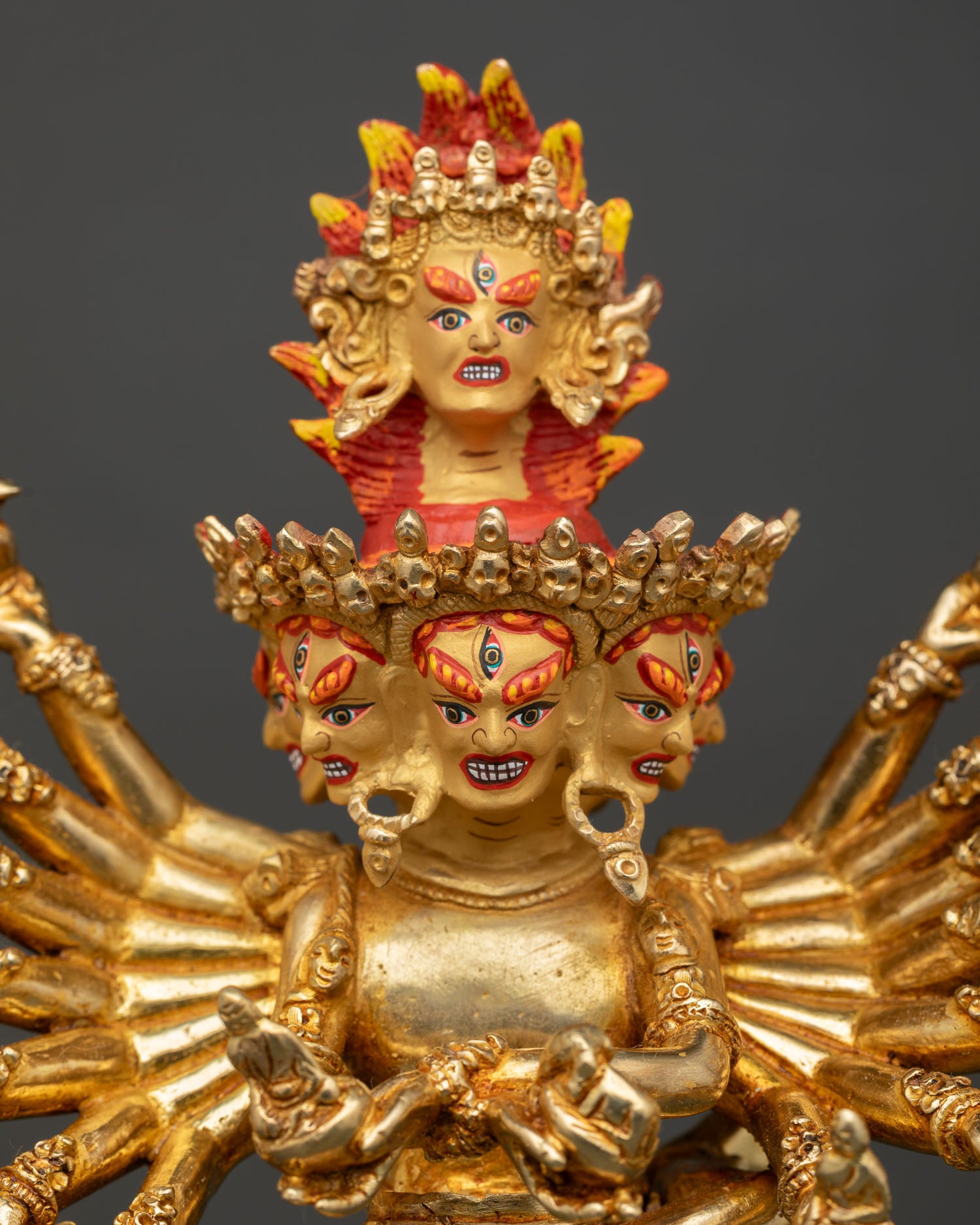 Detailed Face Close Up of Hevajra Statue with Gold Painted Expression and Crowns