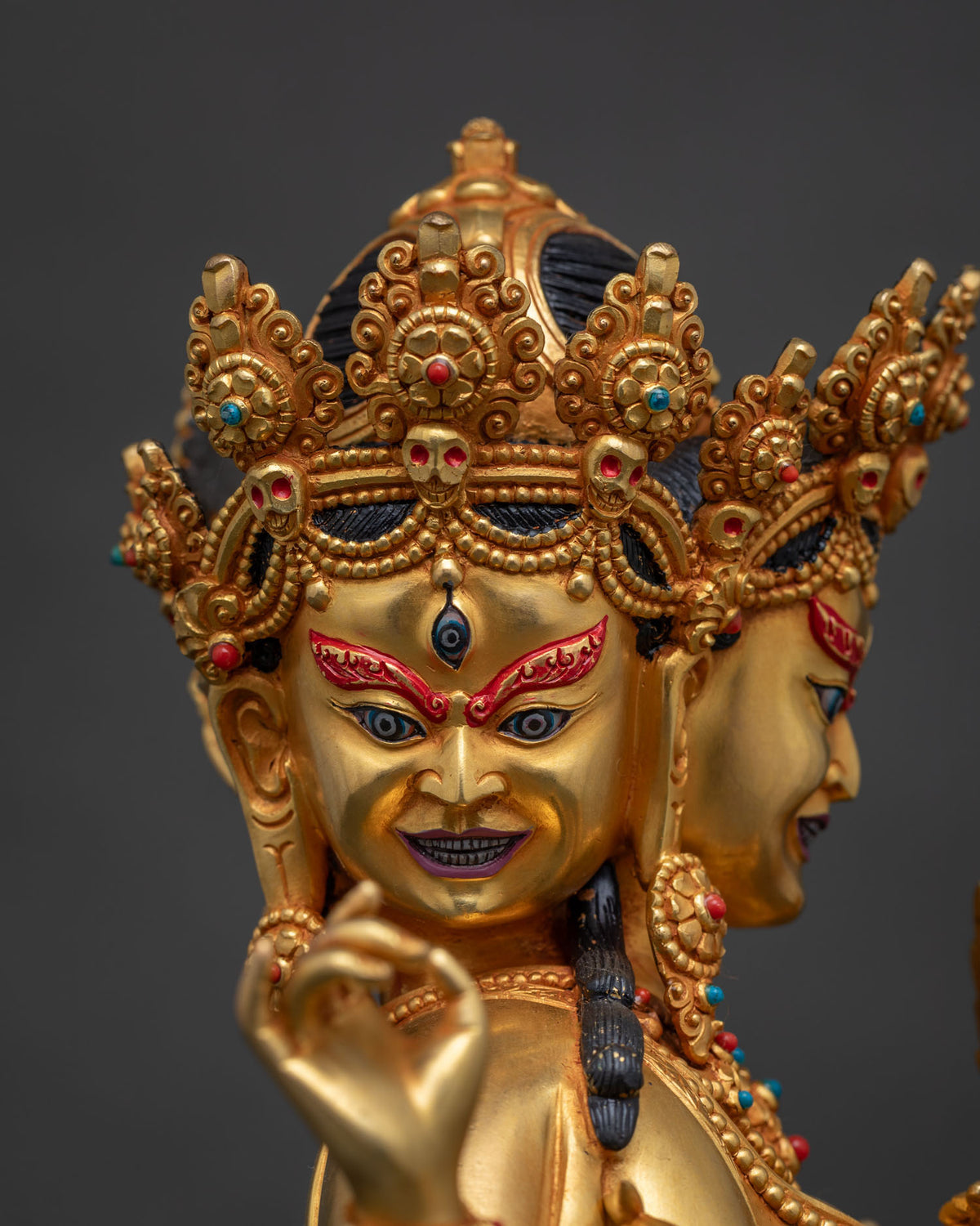 Detailed face close-up of Marichi, skull crown, gold fire-gilded Nepalese sculpture