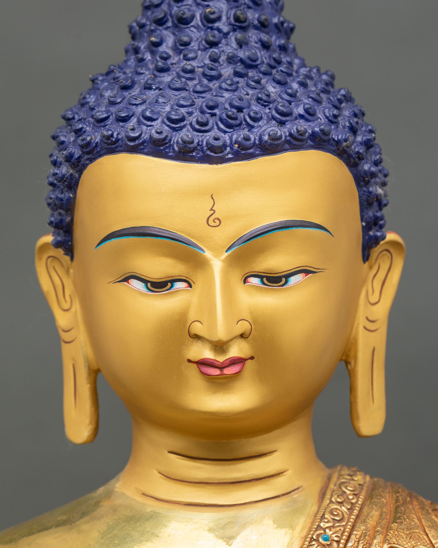 Detailed face close-up of Shakyamuni Buddha, gold fire-gilded with serene expression