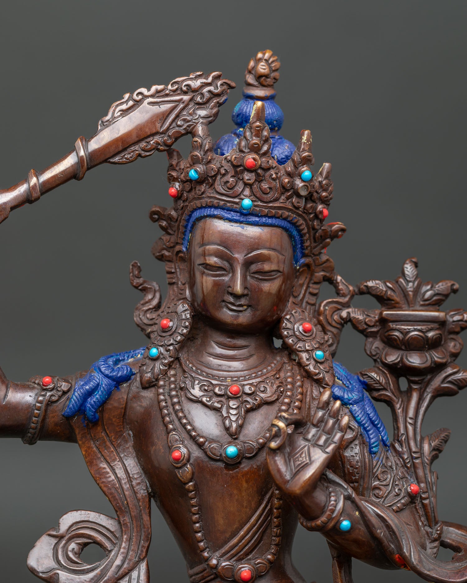 Detailed Manjushri Buddhist statue with turquoise and coral stones and intricate Nepalese craftsmanship