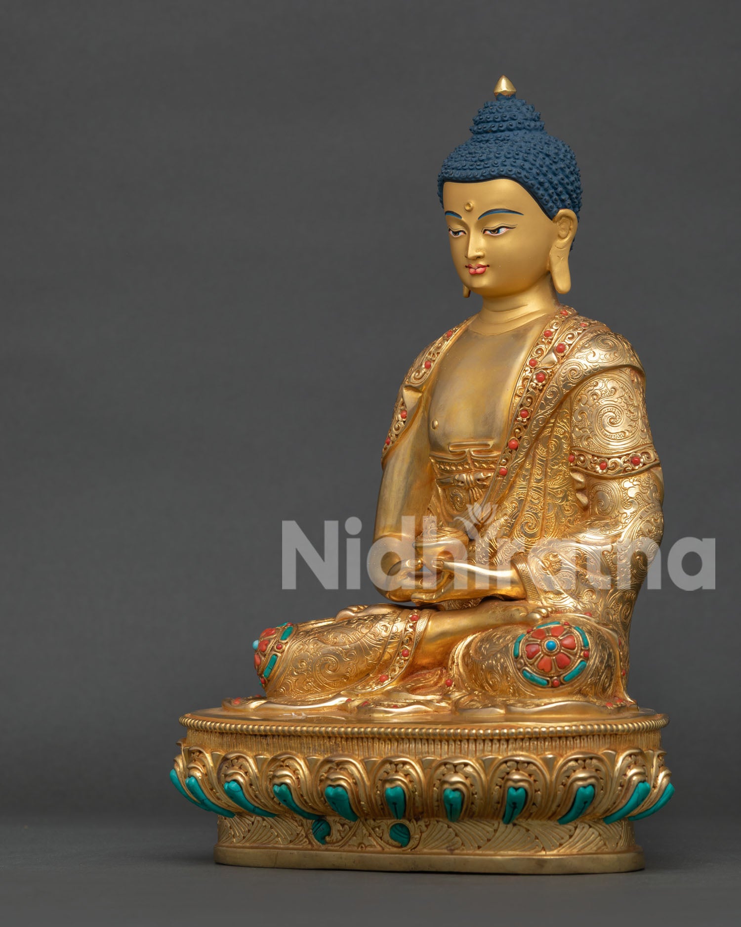 Detailed robe design of Amitabha Buddha sculpture featuring carved floral motifs, gold gilding, and sacred Buddhist patterns