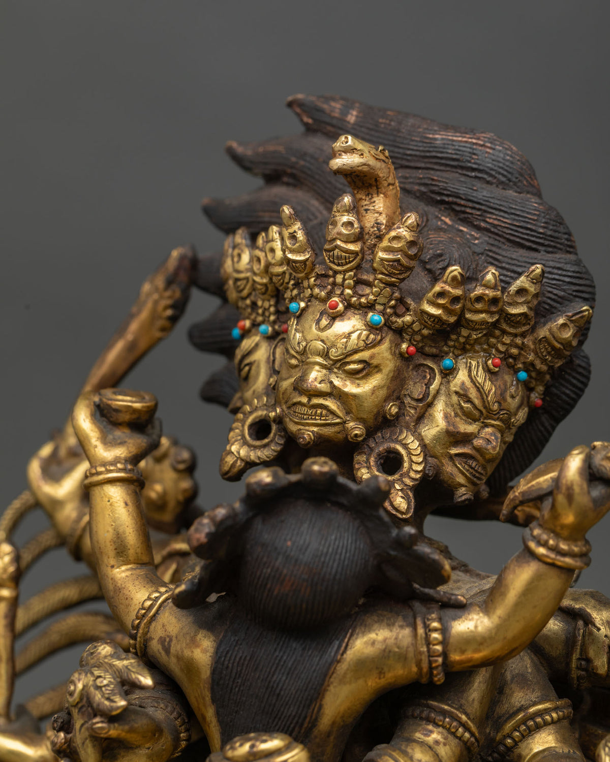 Detailed side close up of antique Hayagriva statue showing hand-carved wings and flame halo