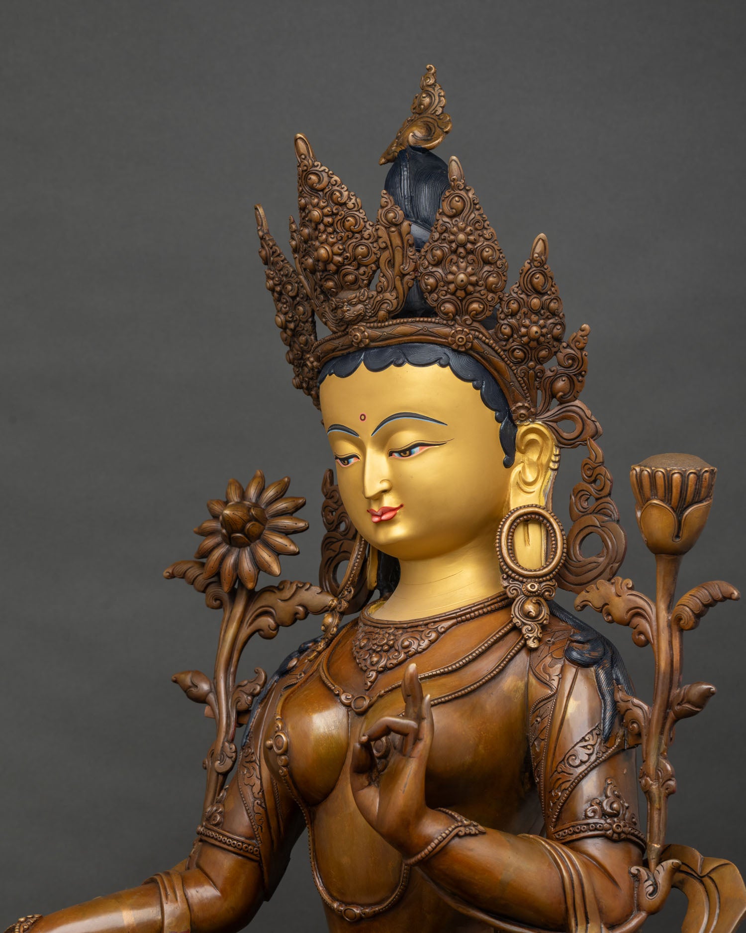 Detailed side close-up of Green Tara statue, flowing garments, finely carved lotus throne
