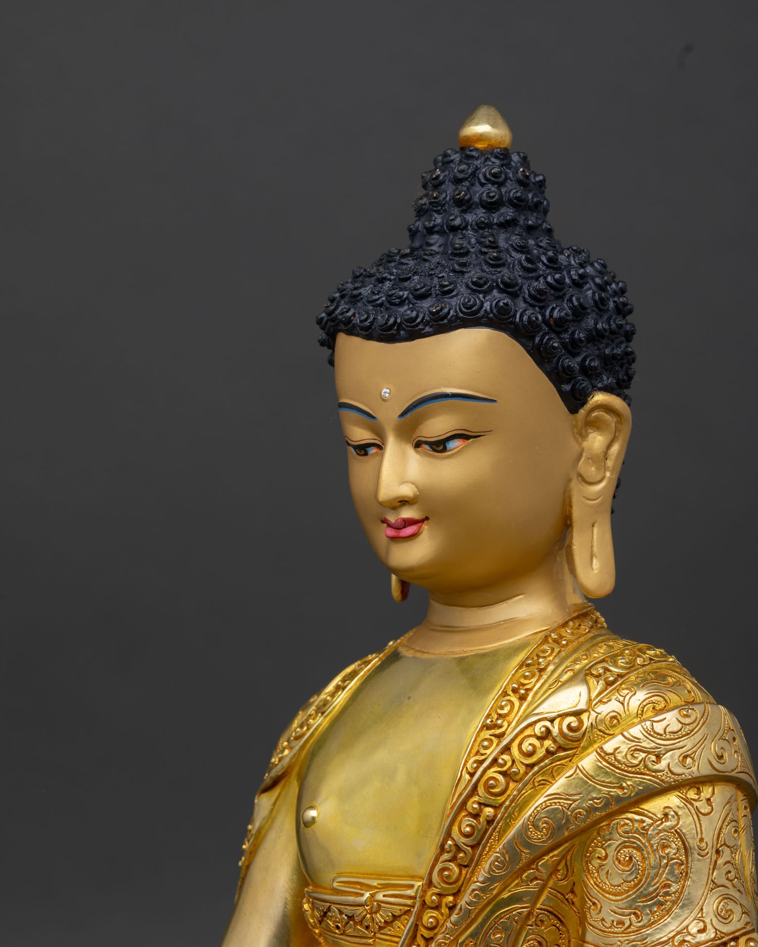Detailed side close-up of Shakyamuni Buddha statue showing patterned sanghati robe