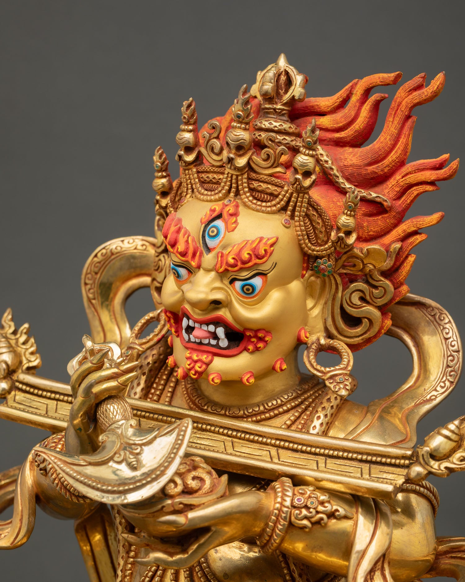 Detailed side view of Shakya Mahakala statue with sacred ornaments and copper craftsmanship