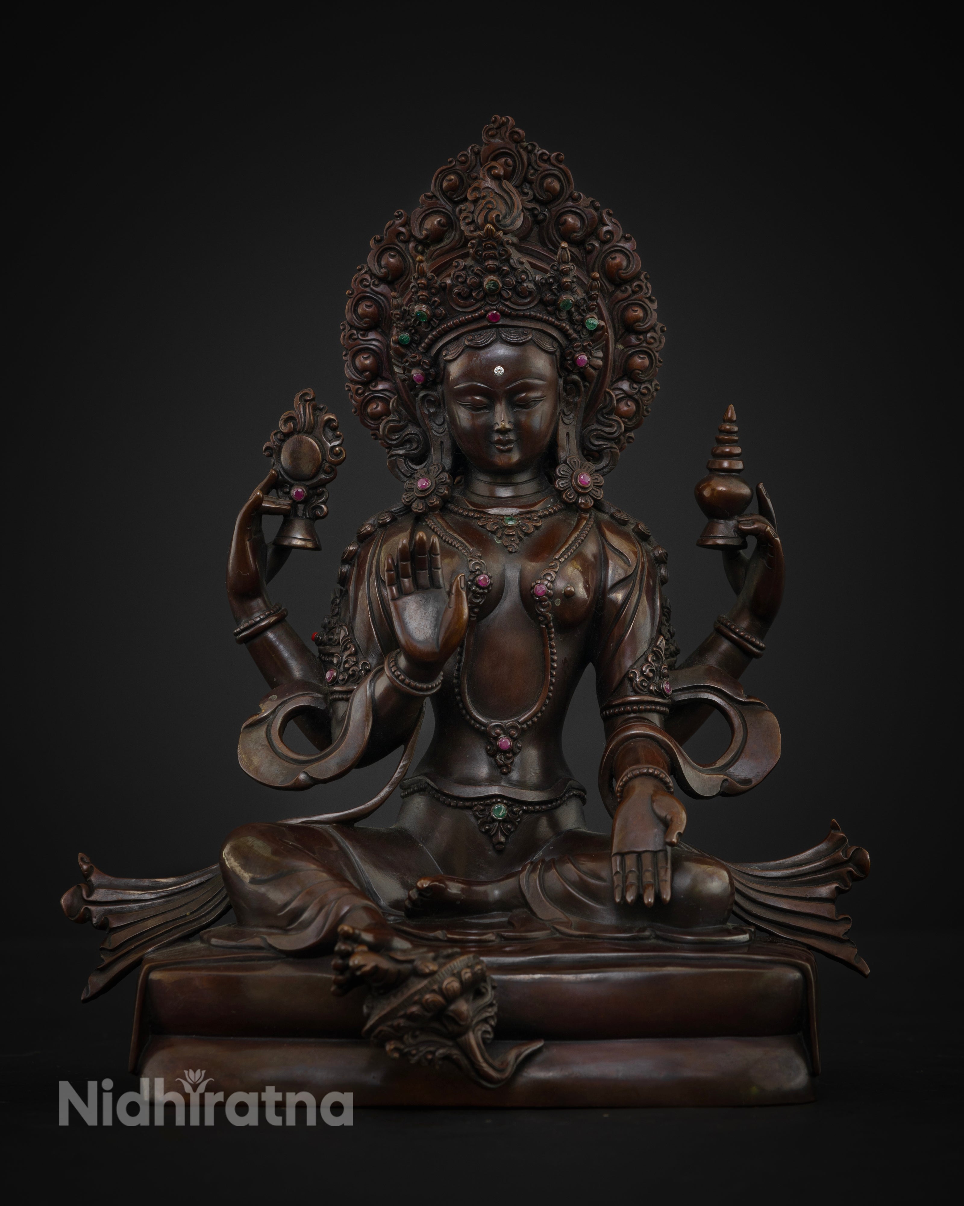 Detailed view of Goddess Lakshmi, with a flaming halo adorned with gemstone inlays and ornate scrollwork craftsmanship
