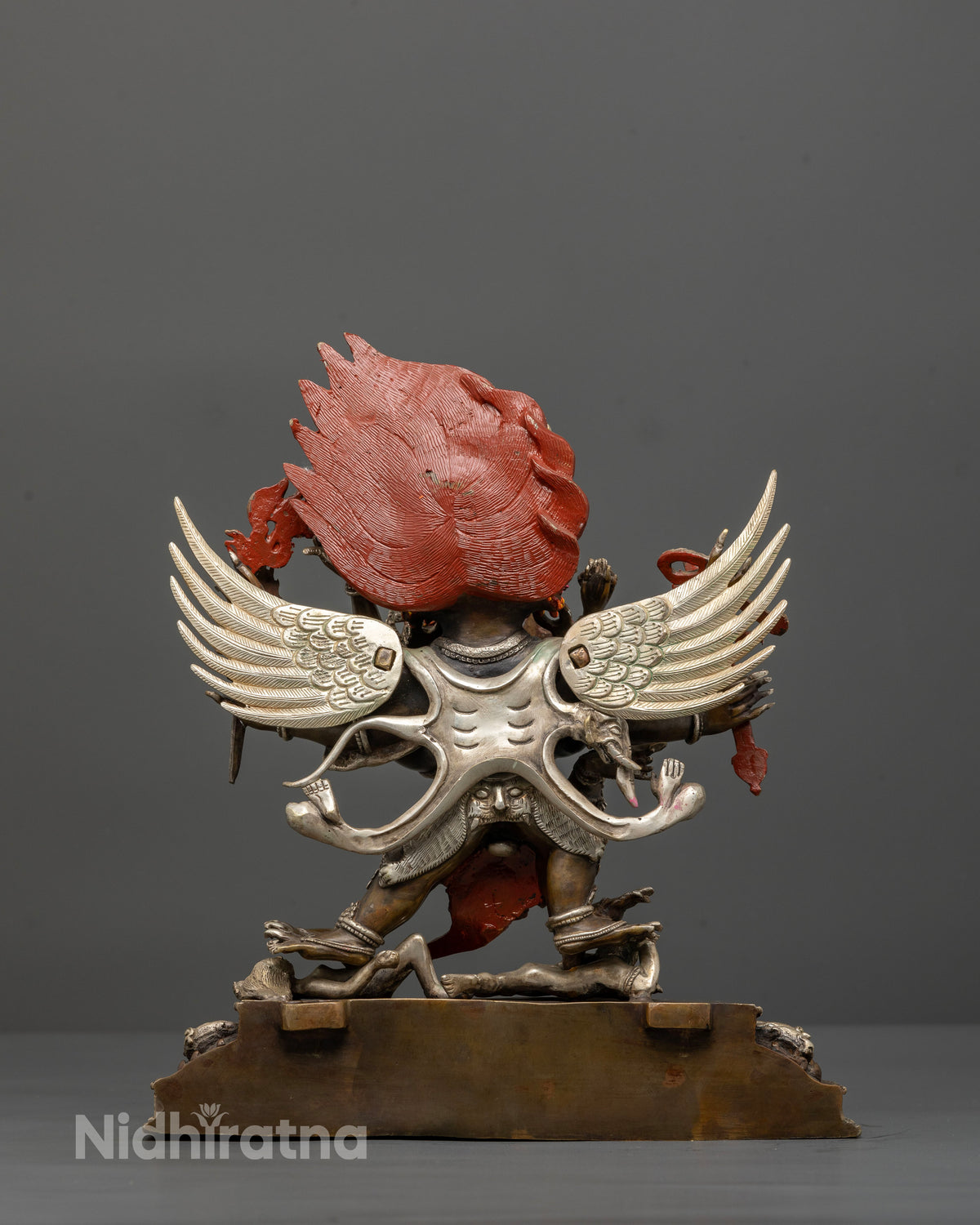 Detailed view of Hayagriva statue with multiple arms and finely carved feathers