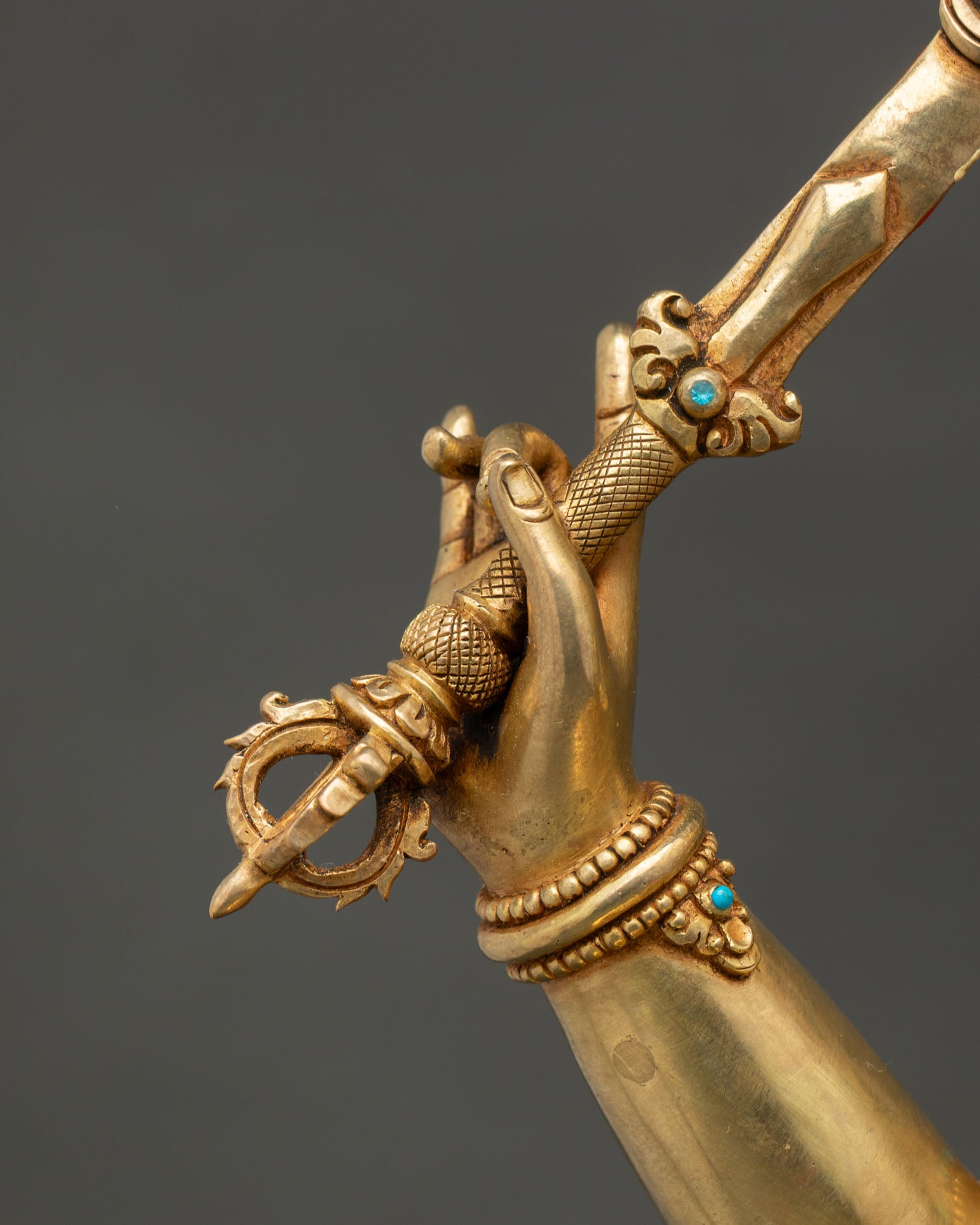 Detailed view of Manjushri's flaming wisdom sword with traditional Nepalese metal artistry