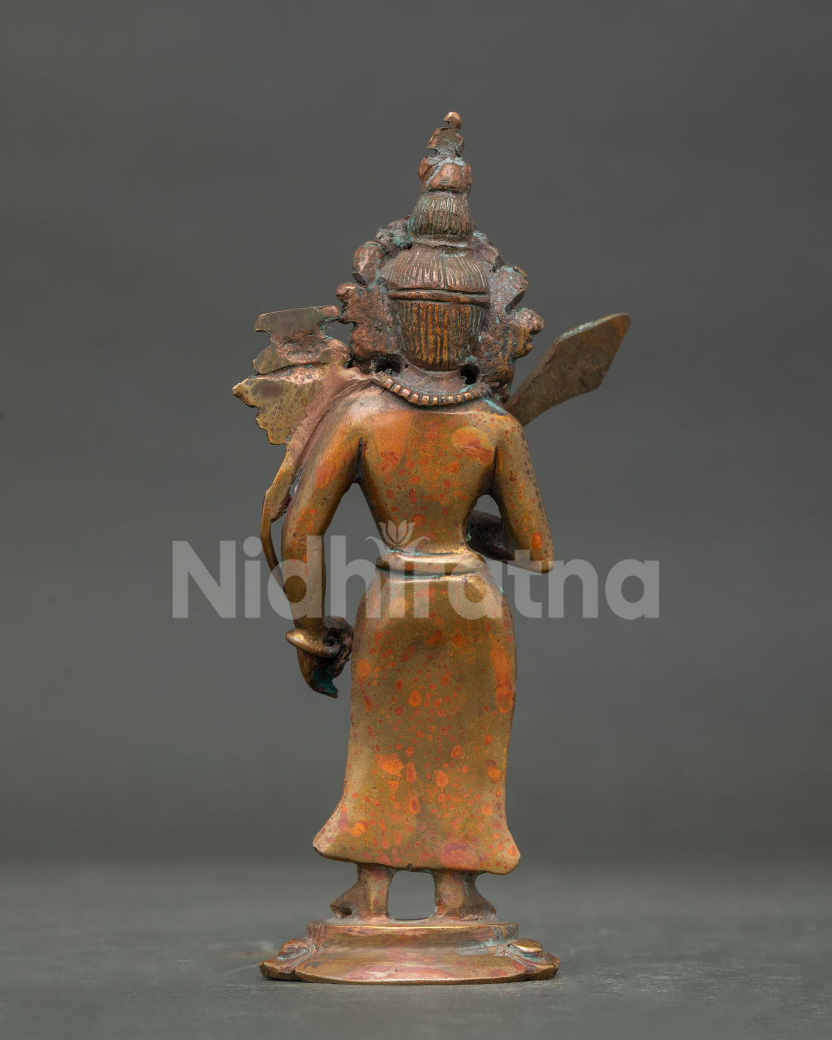 Detailed view of Manjushri statue with utpala lotus stem and sacred scripture.