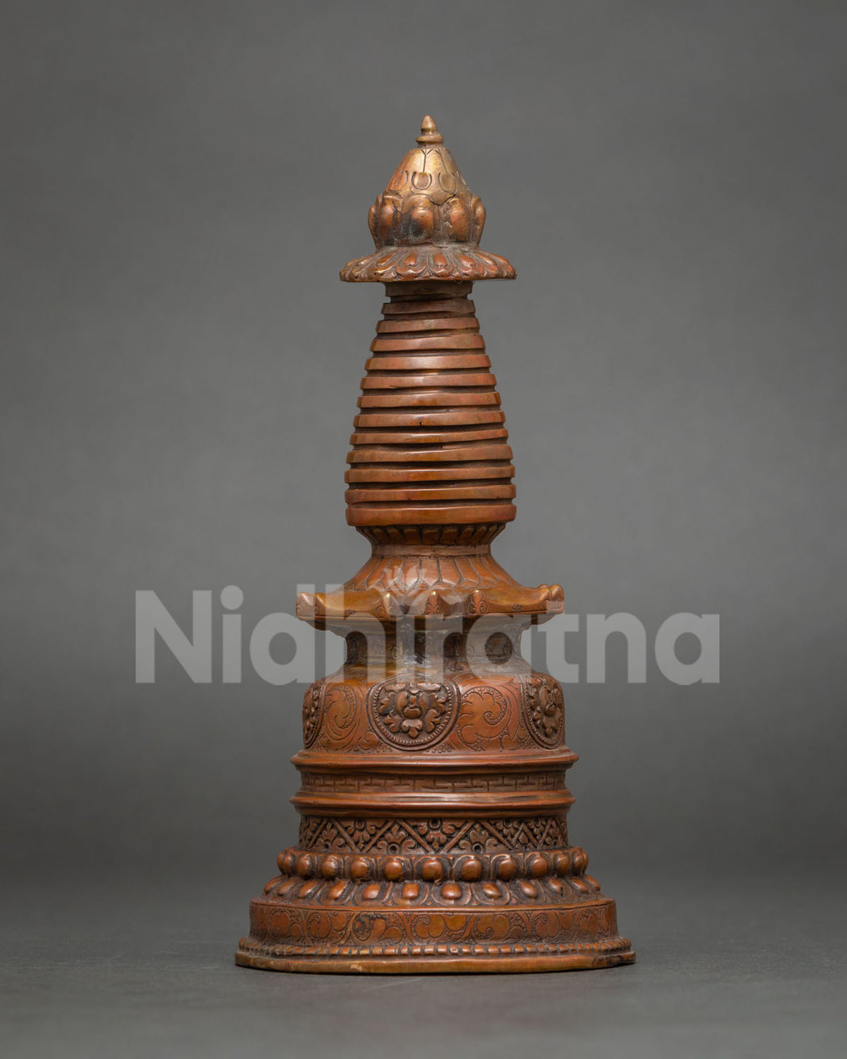 Detailed view of oxidized copper Kadampa Stupa with bell-shaped base and stepped harmika