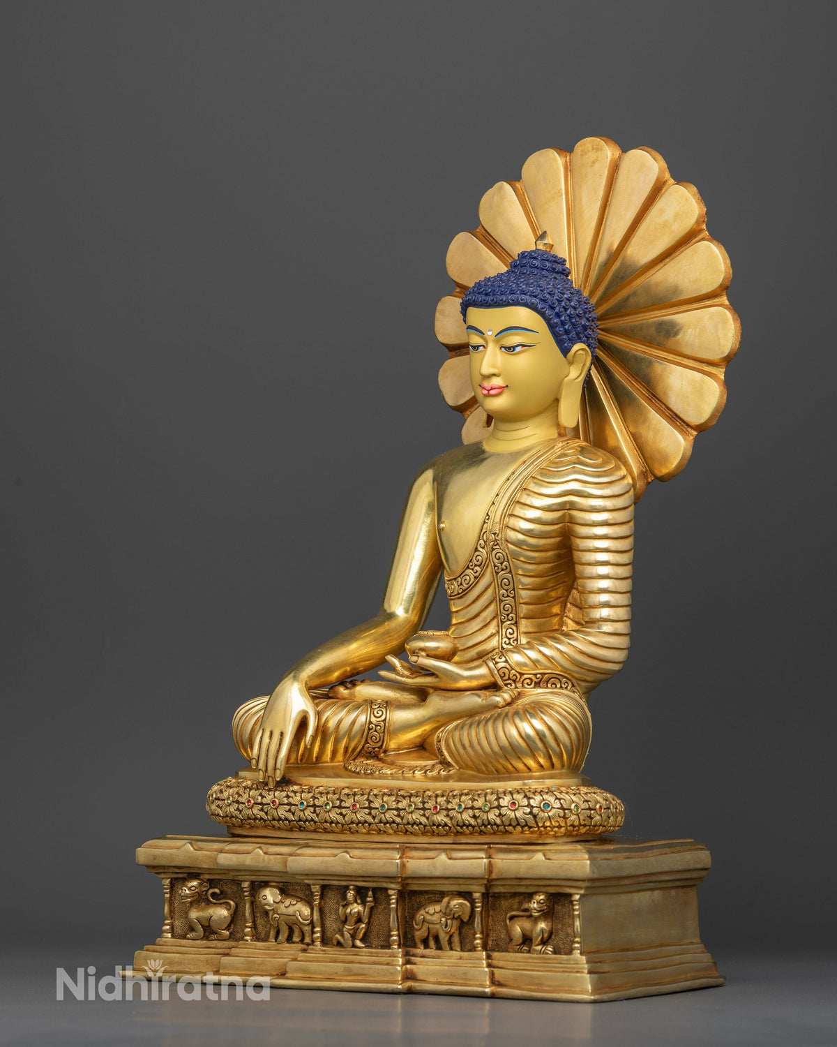 Detailed view of Shakyamuni Buddha throne base featuring carved lions, elephants, sacred figure, and intricate floral motifs