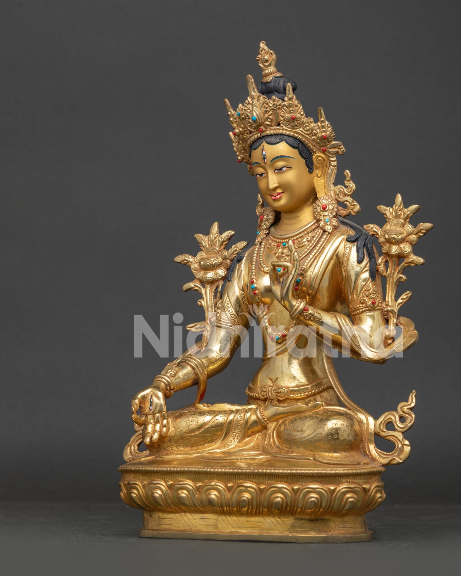 Detailed White Tara Statue seated on lotus pedestal with flowing robes and sacred symbolism.