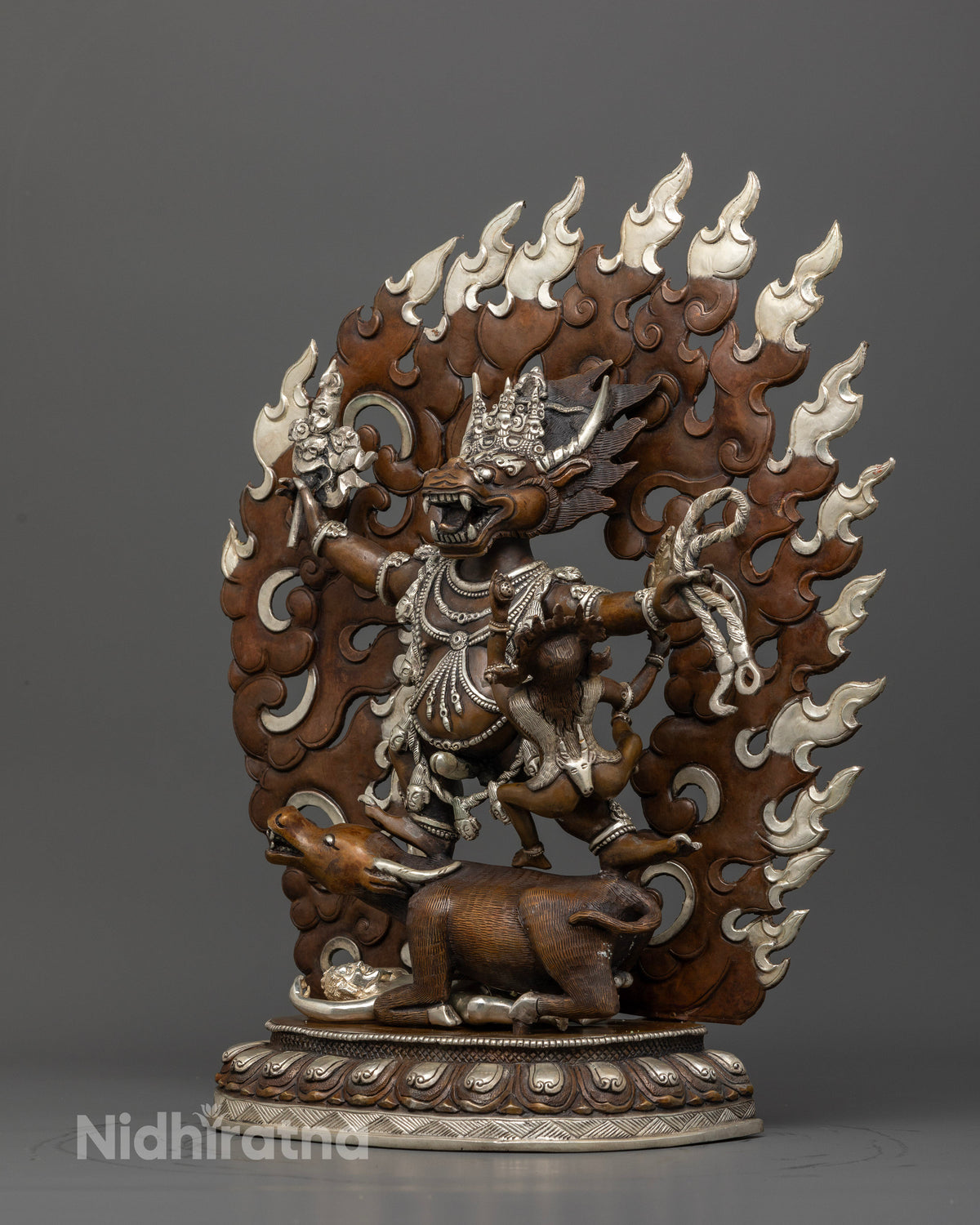 Detailed Yamantaka statue standing on buffalo with blazing halo.