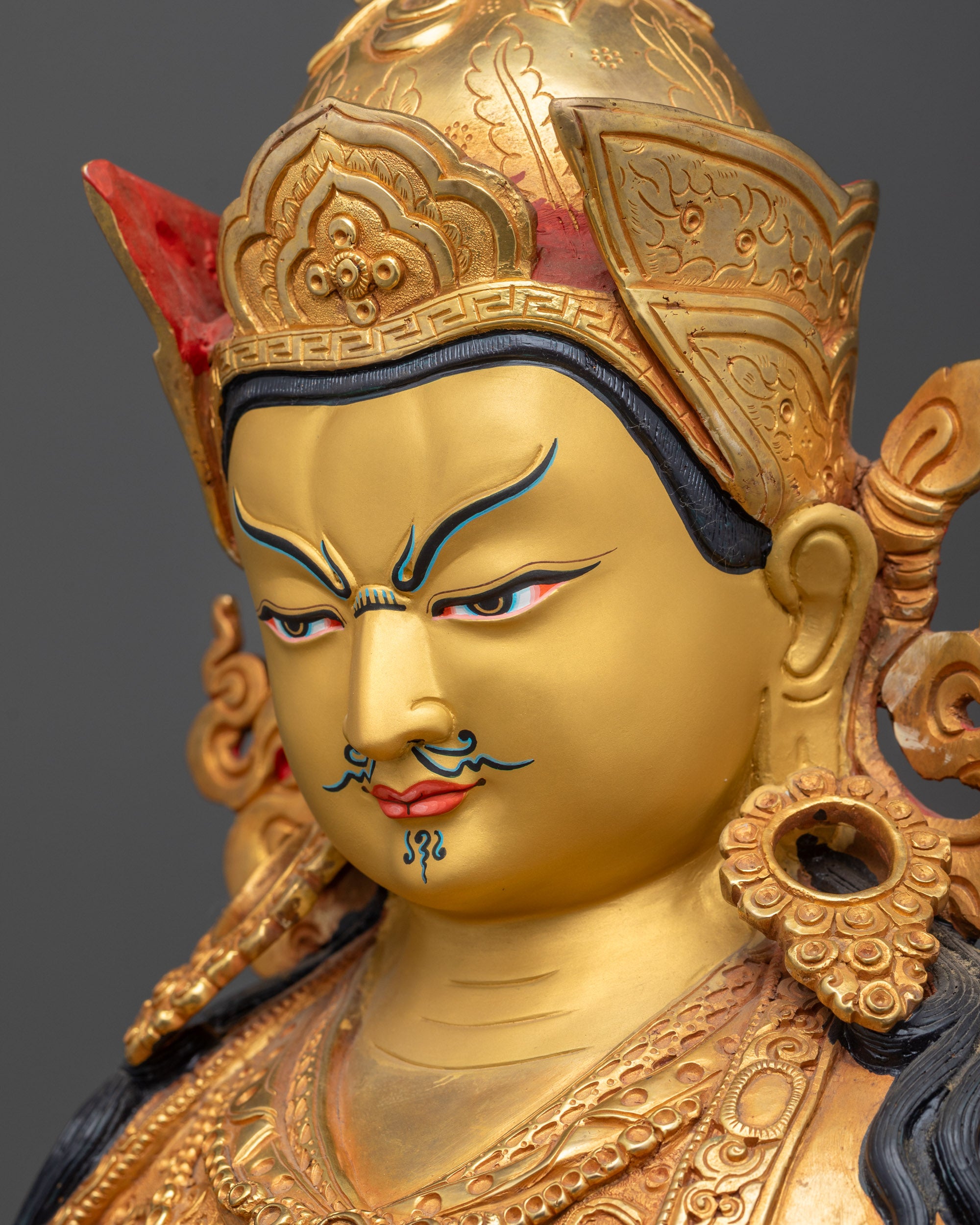 detailed Side close up face Guru Rinpoche statue wrathful compassionate expression gold gilded