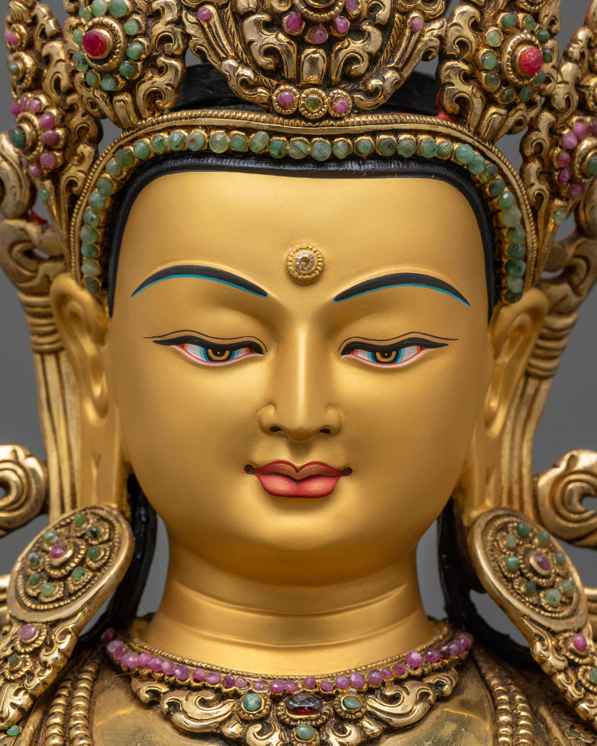 detailed close up face Vajrasattva statue with five-jewelled crown and gold-gilded face