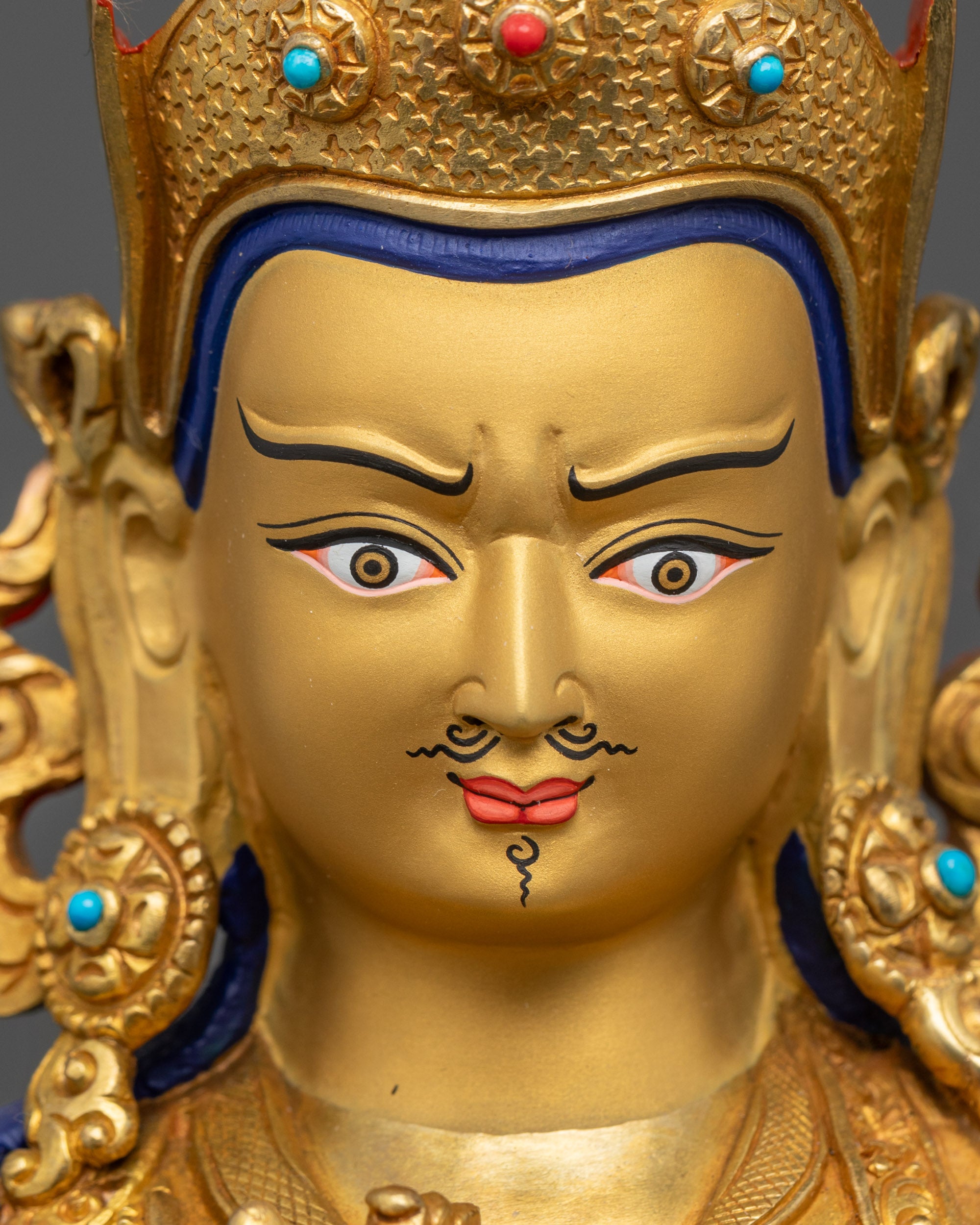 detailed close up face of Tsokye Dorje with wrathful gold-gilded expression and lotus hat