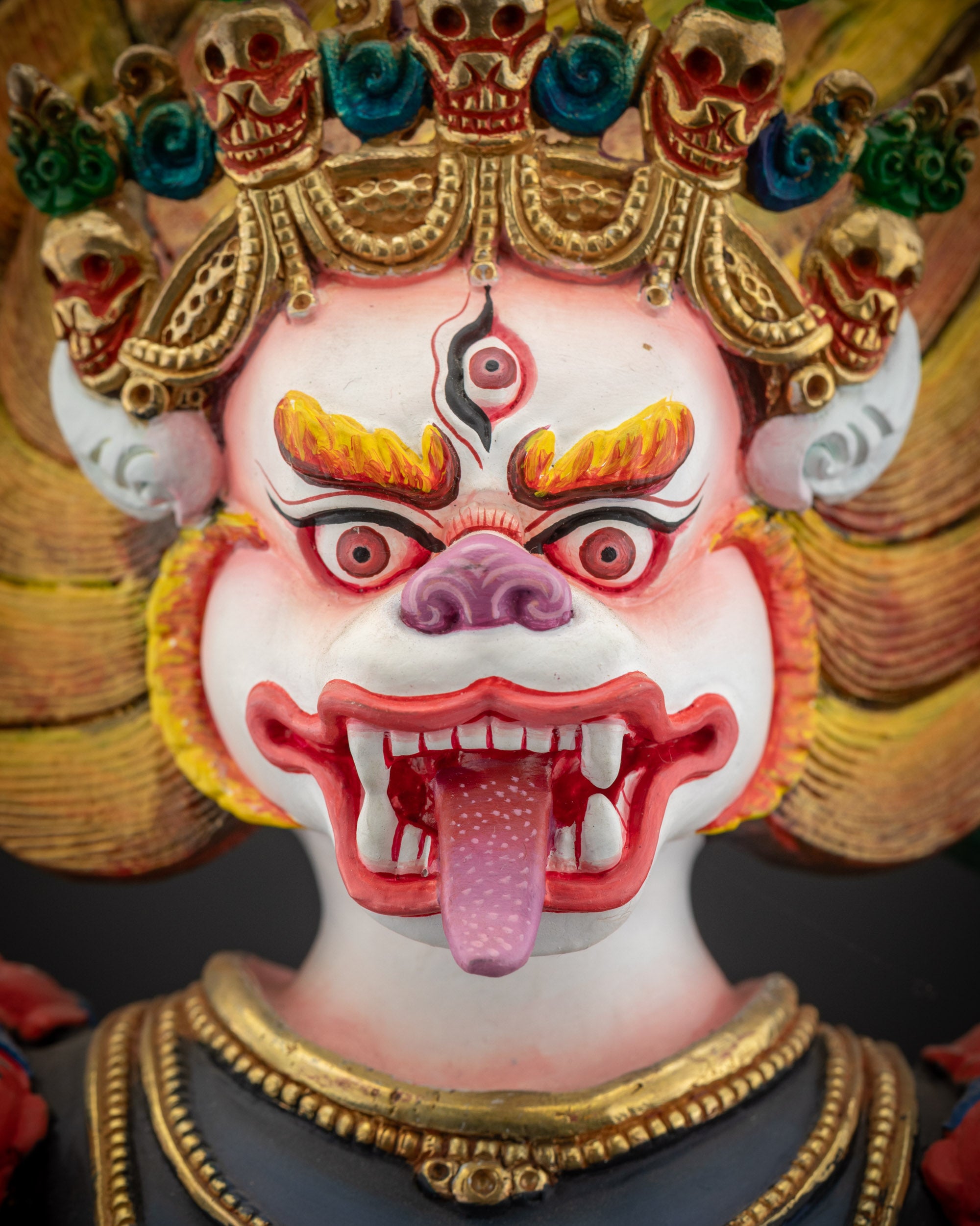 detailed close up of face Simha Mukha statue with fierce expression and piercing eyes