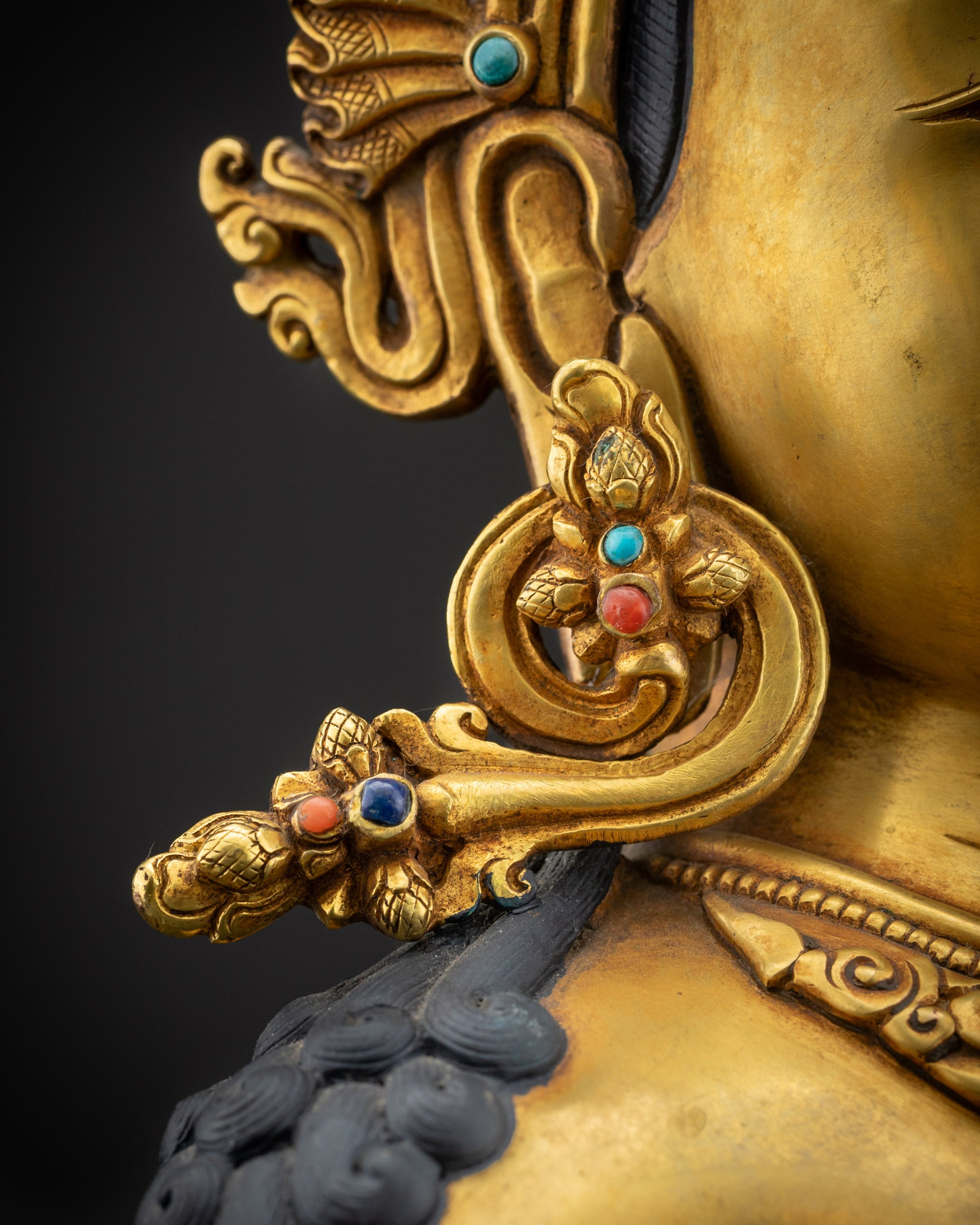 detailed earrings chenrezig statue with jeweled earrings and carvings
