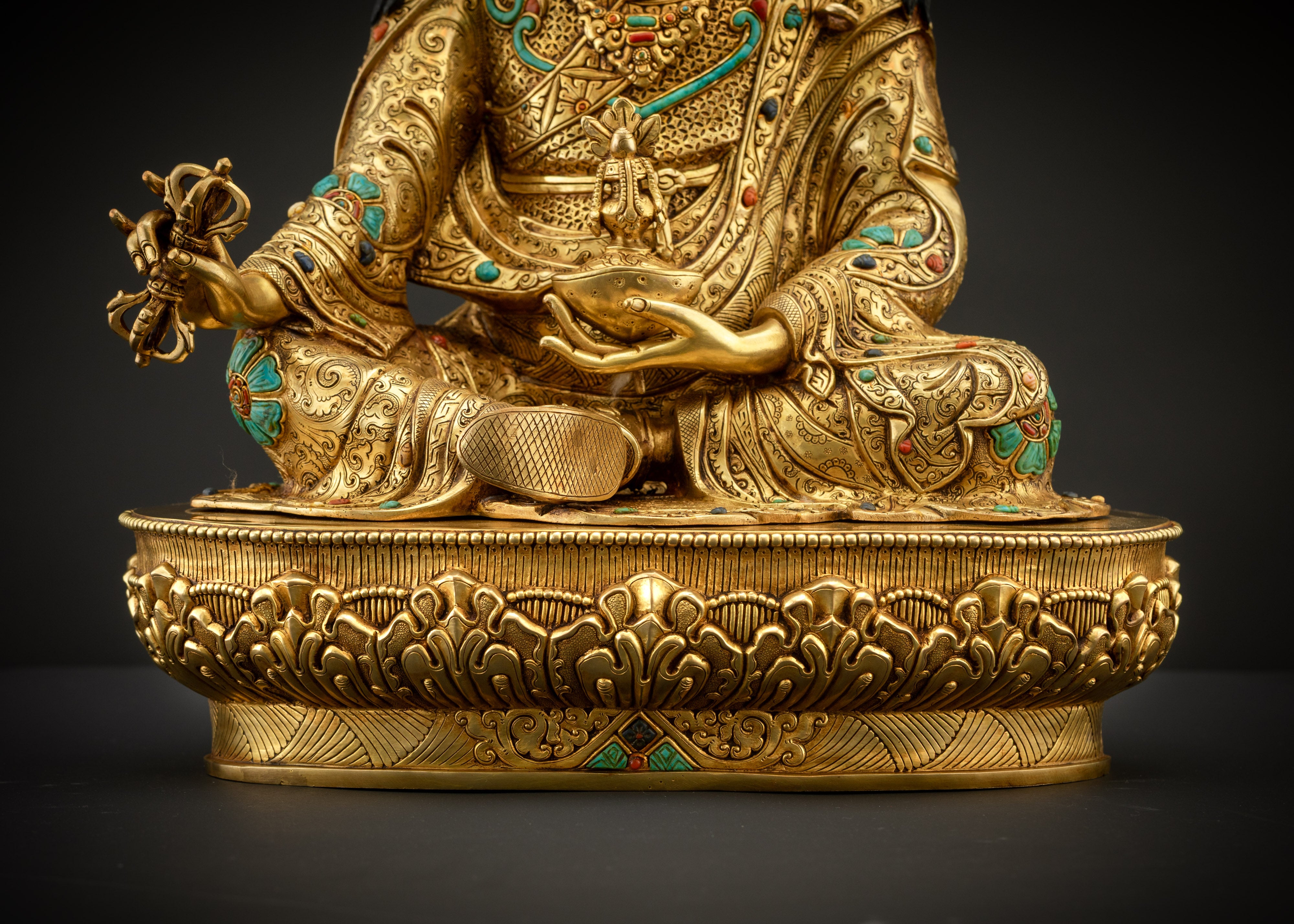 detailed landscape shot of guru seated on lotus seat front 24K gold gilded statue Nepal