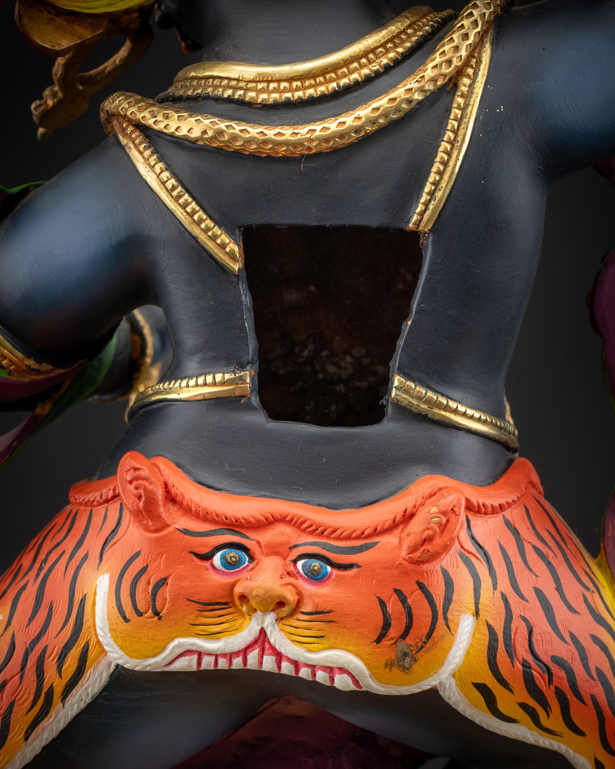 detailed robe back view Vajrapani statue highlighting swirling tiger-skin and flame motifs