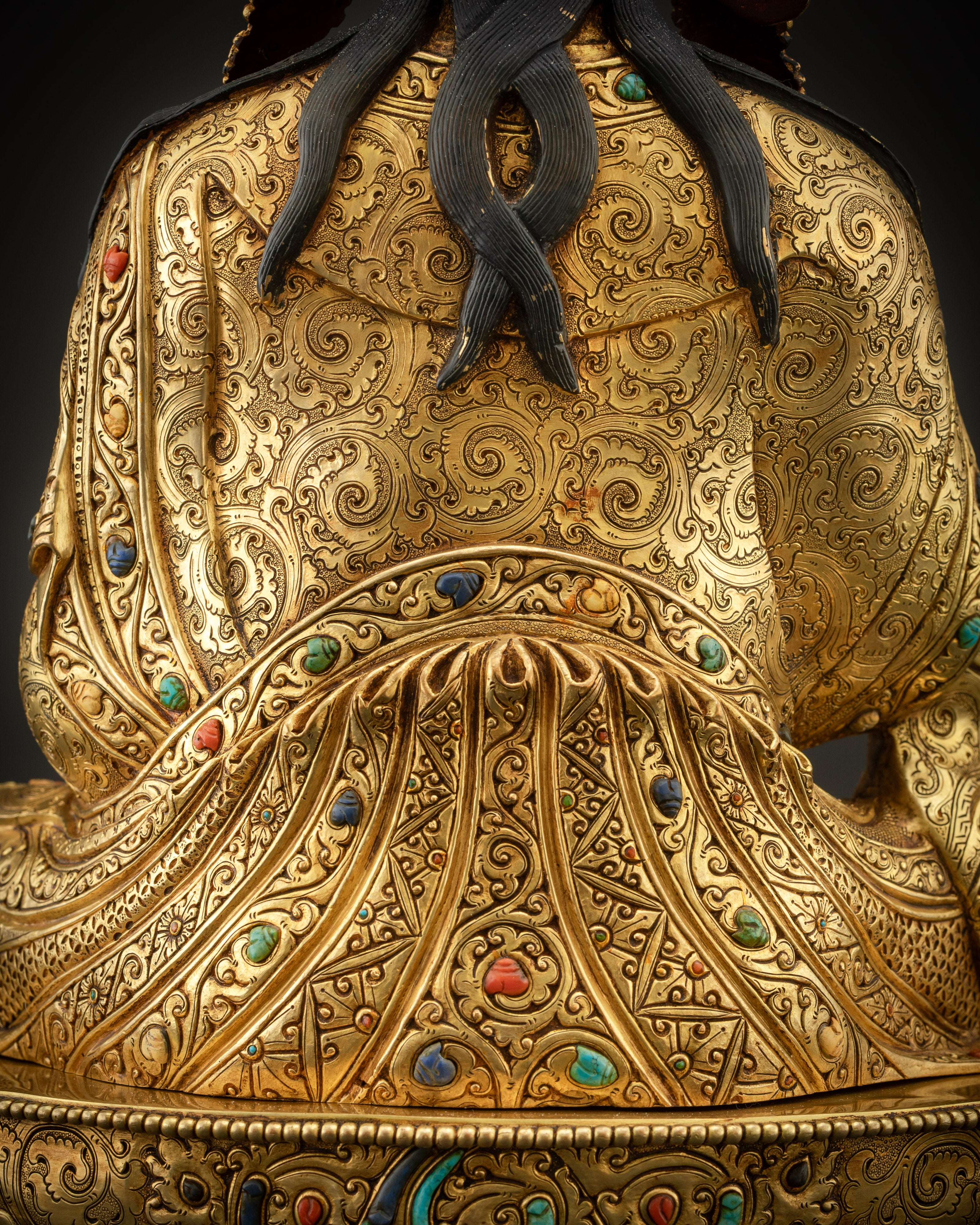 detailed shot of back Padmasambhava Guru Rinpoche statue motifs and copper detailing