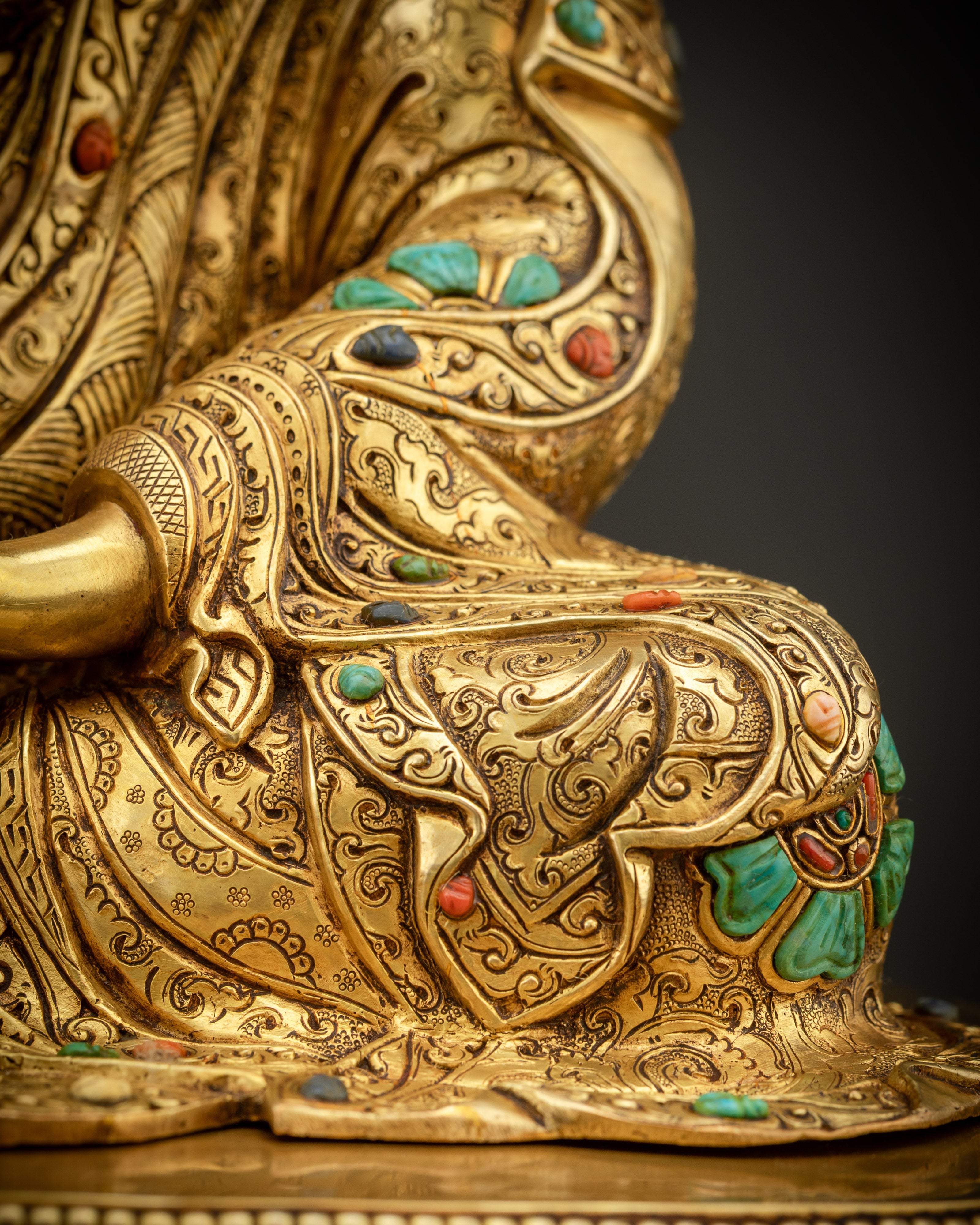 detailed shot of robe Padmasambhava statue gold gilded kasaya robe and fine carvings