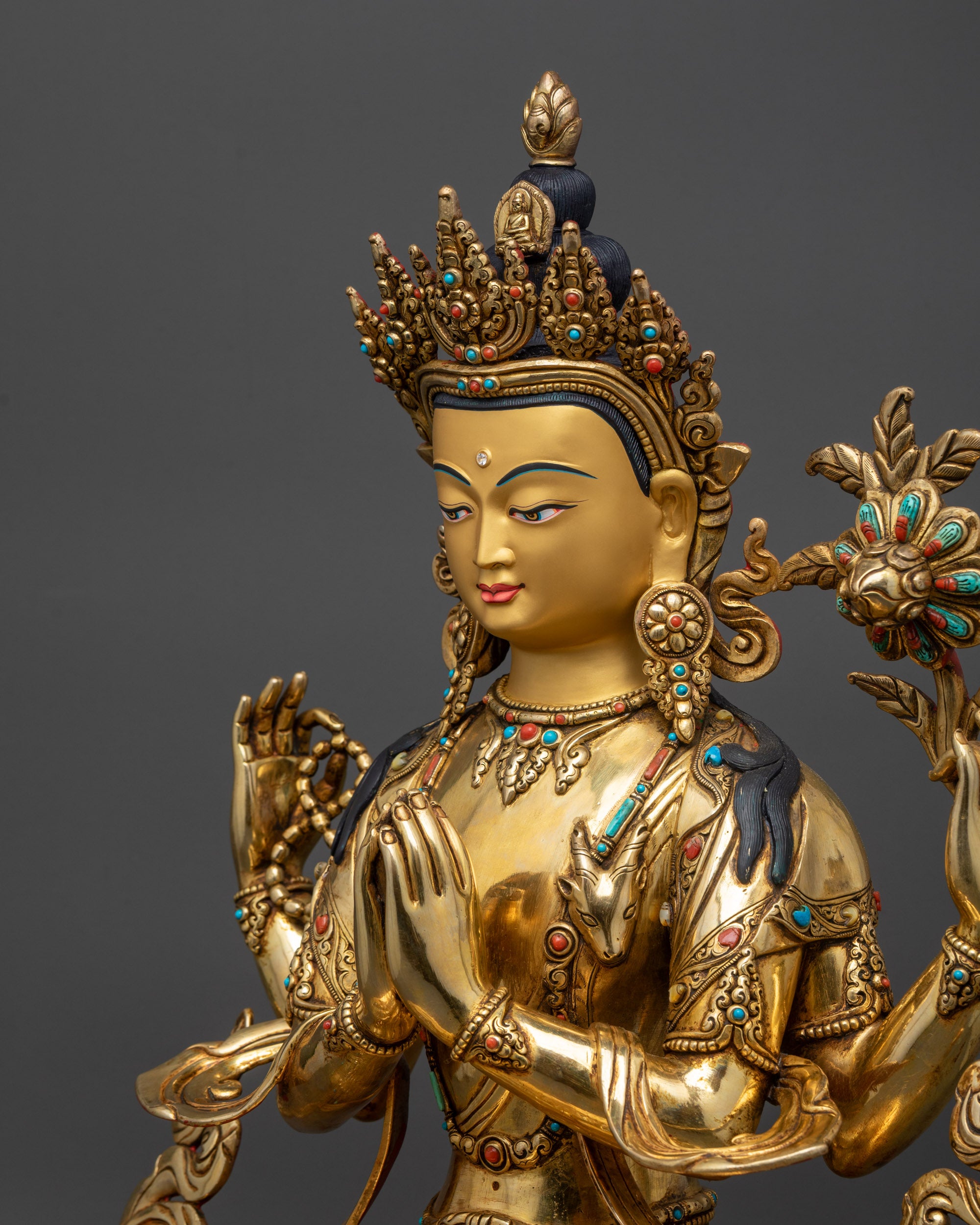 detailed side close up Four-Armed Chenrezig statue showing armlets, lotus and sacred objects