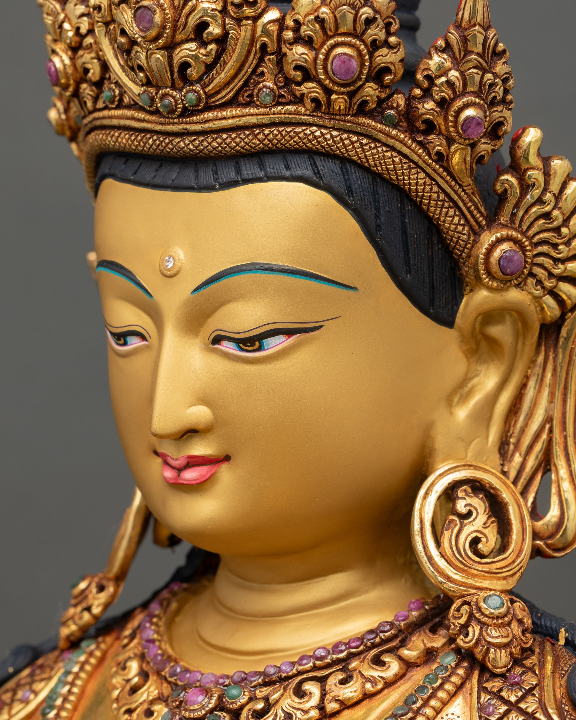 detailed side close up face of Vajrasattva Sculpture with crown and gold fire-gilding