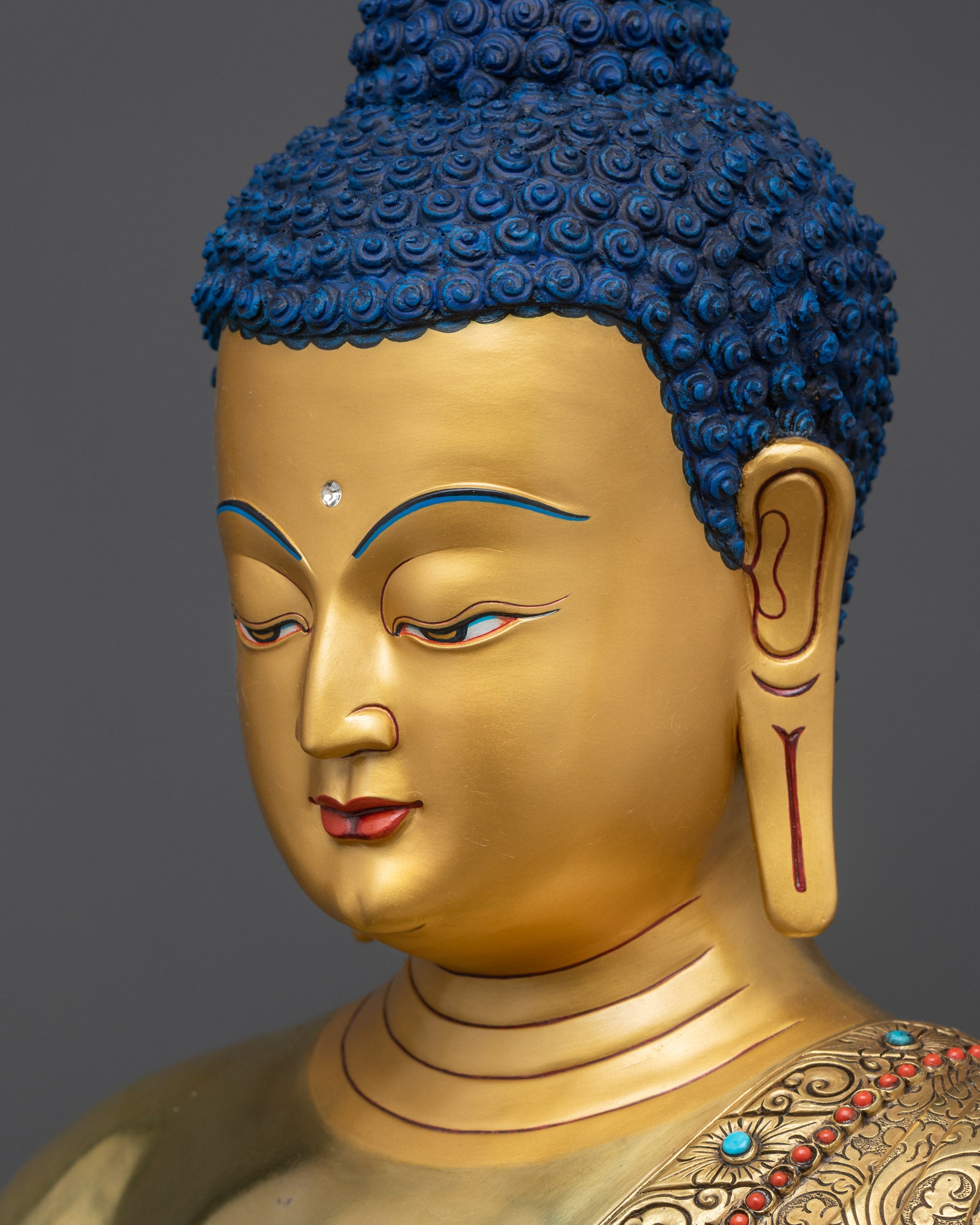 detailed side close up of Medicine Buddha Statue with gold-gilded halo and intricate robe details