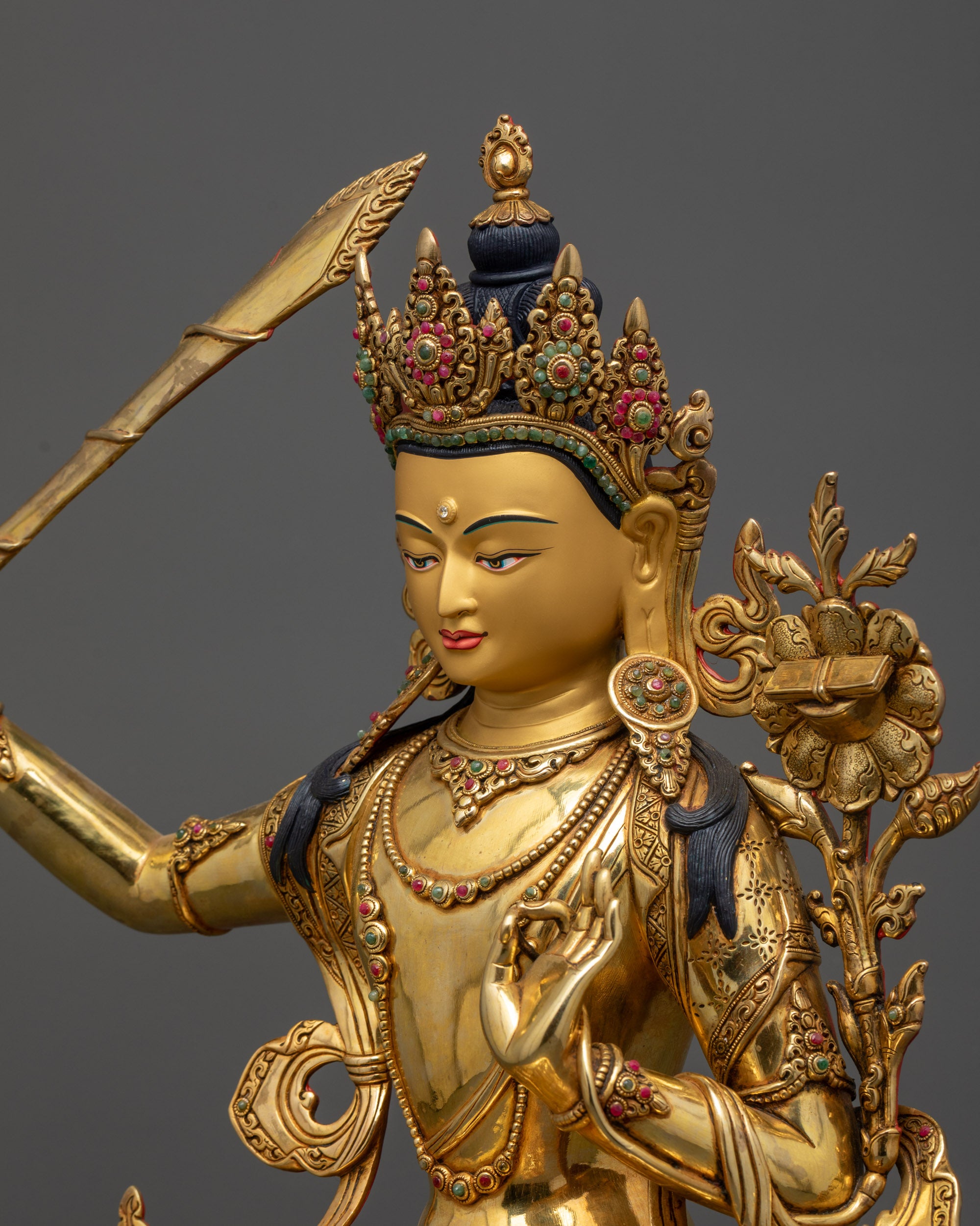 detailed side view Manjushri Statue with utpala flower, sutra and ornate jewelry