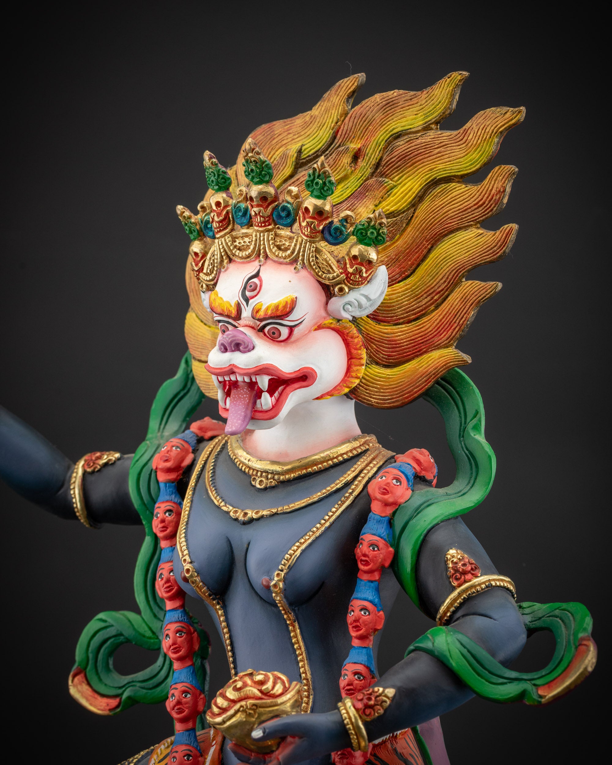 detailed side view Simha Mukha statue showing skull crown, khatvanga, and jewelry