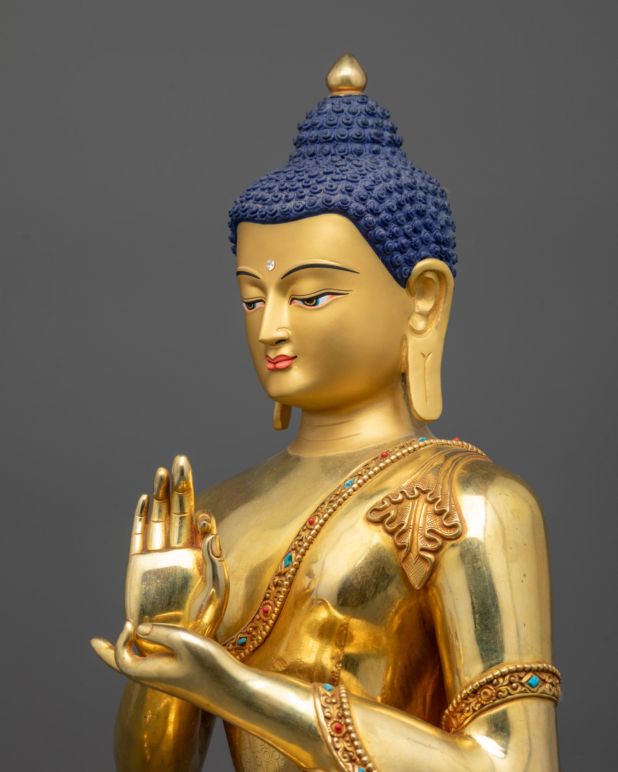 detailed side view Suvarna Bhadra Vimala statue showing robe folds and lotus pedestal