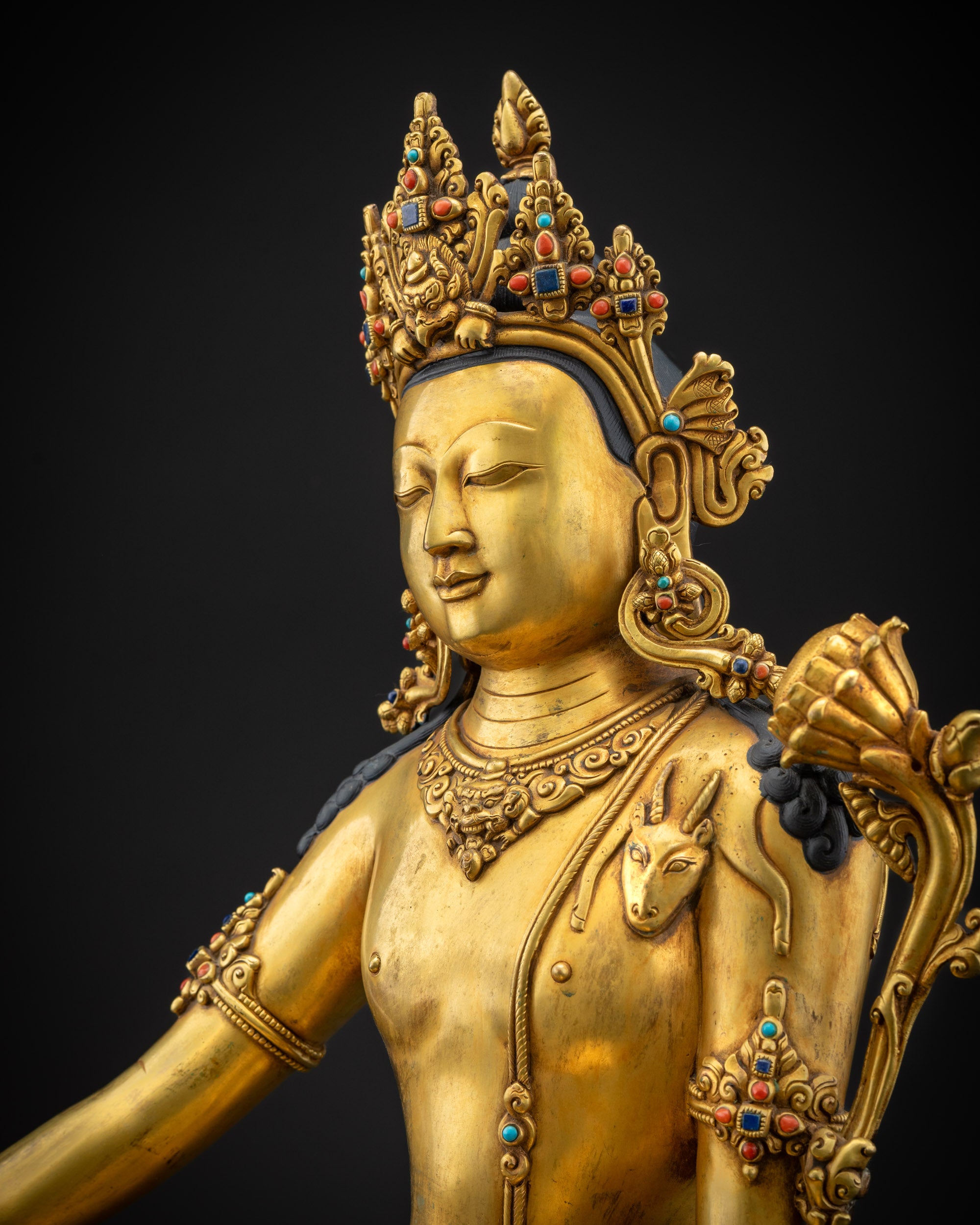 detailed side view chenrezig statue highlighting lotus and carved jewelry