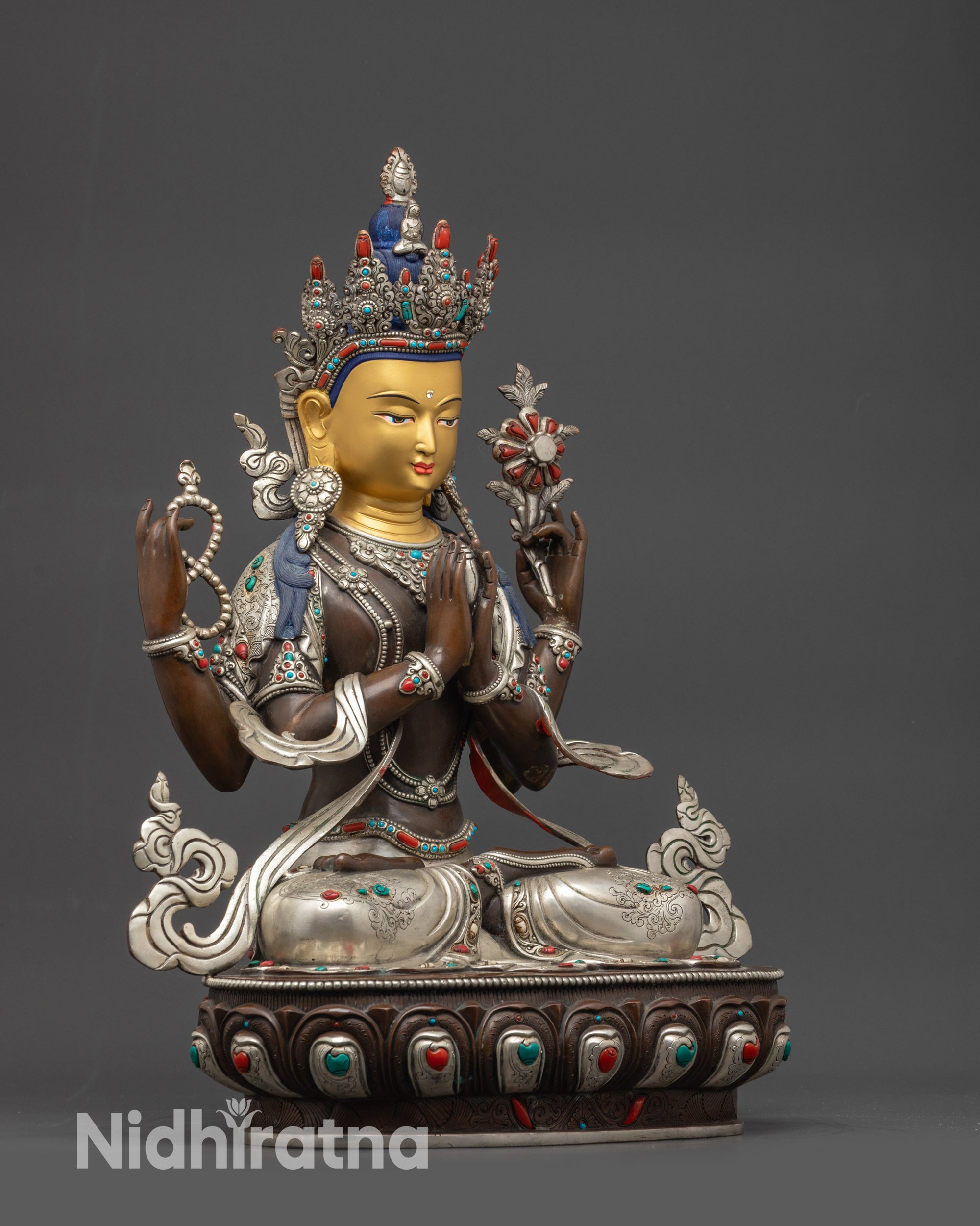 detailed side view of four-armed oxidized Chenrezig holding mala, lotus, and cintamani jewel