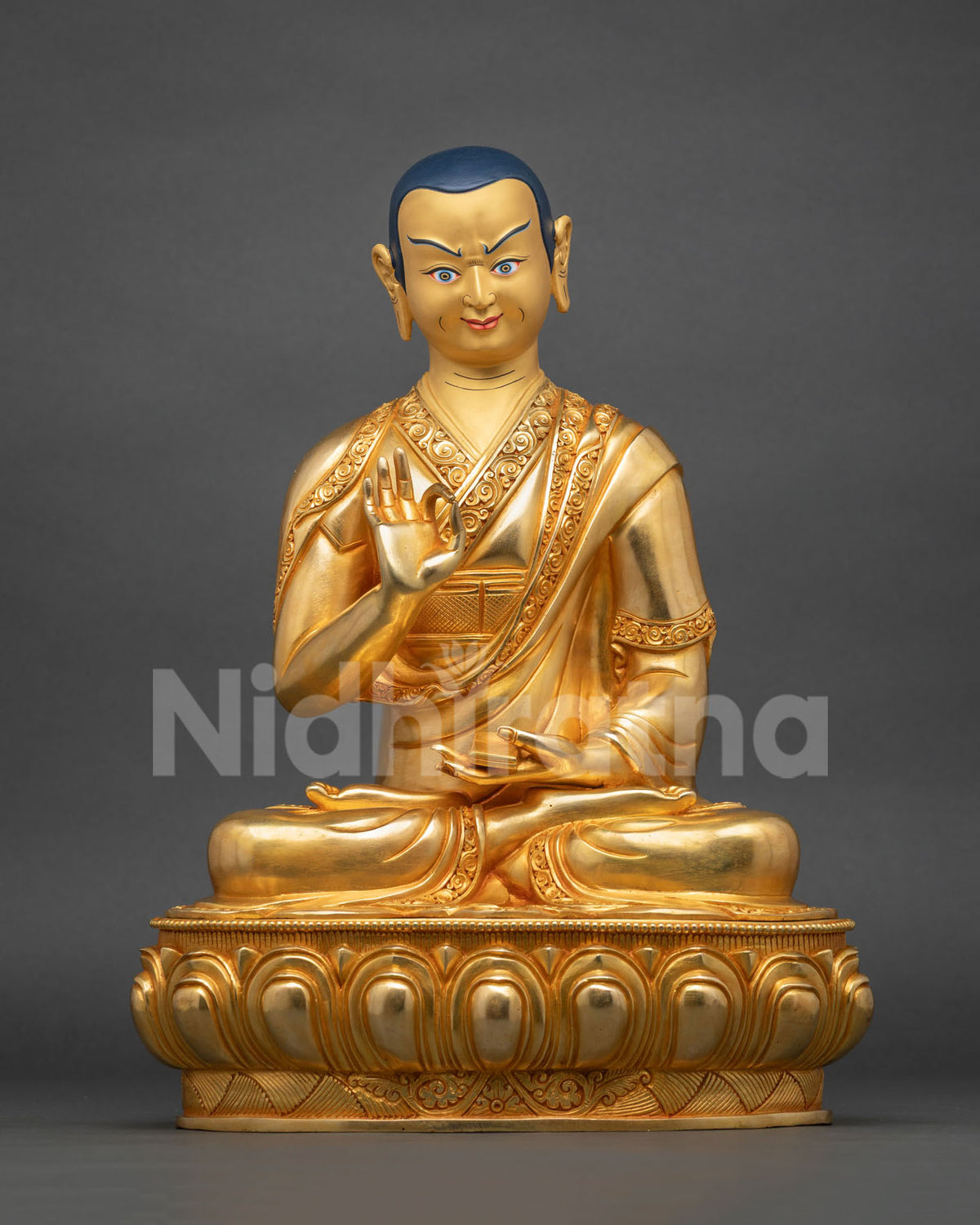 Disciple with deep blue hair, one hand raised in teaching gesture, the other resting in meditative repose