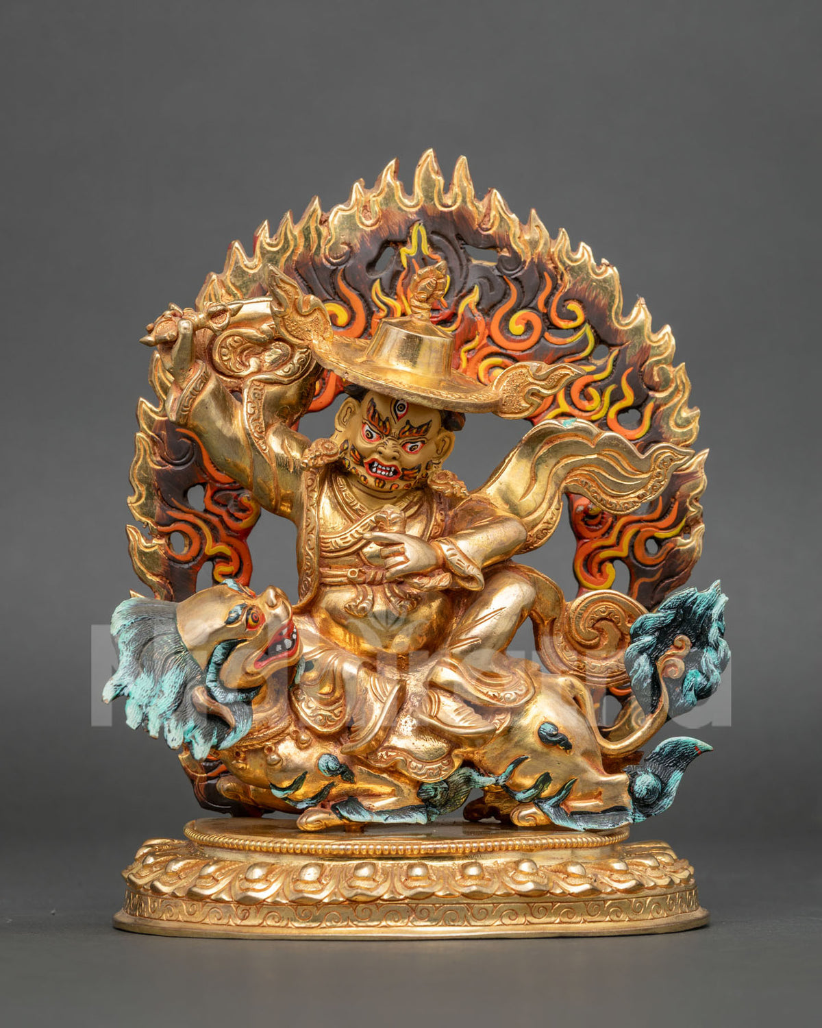 Dorje Legpa statue seated on a snow lion holding a vajra with gold-gilded details