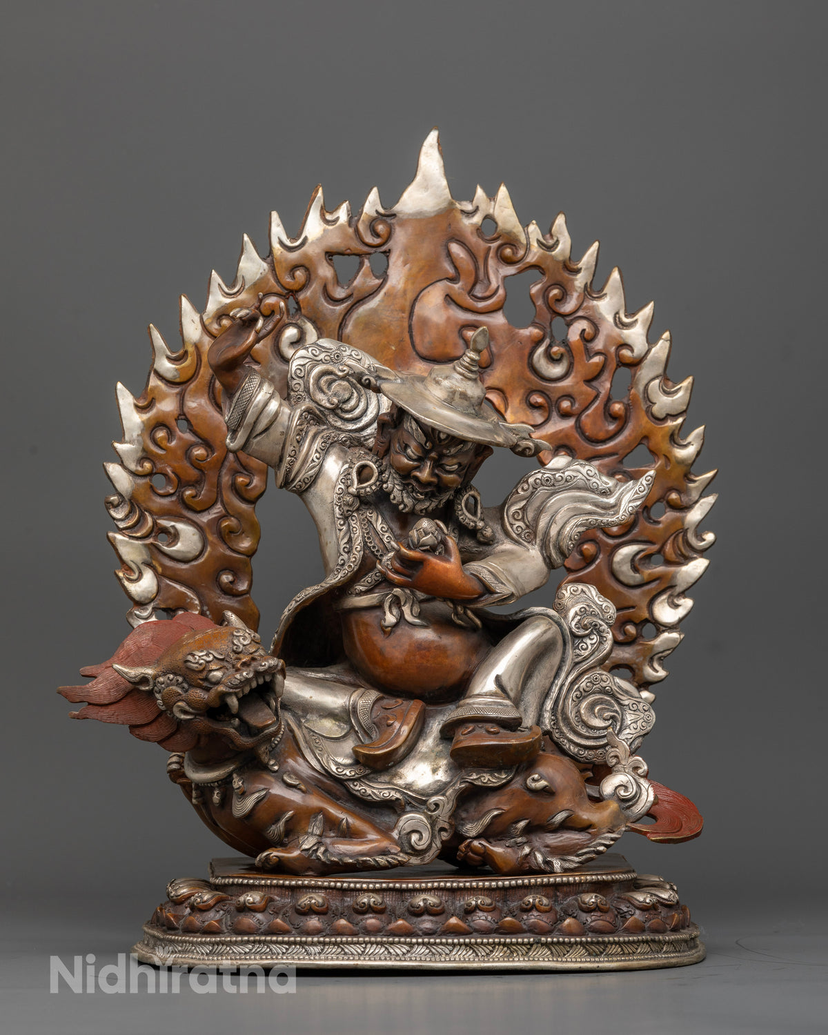 Dorje Lekpa statue seated on snow lion with oxidized copper and silver-plated finish