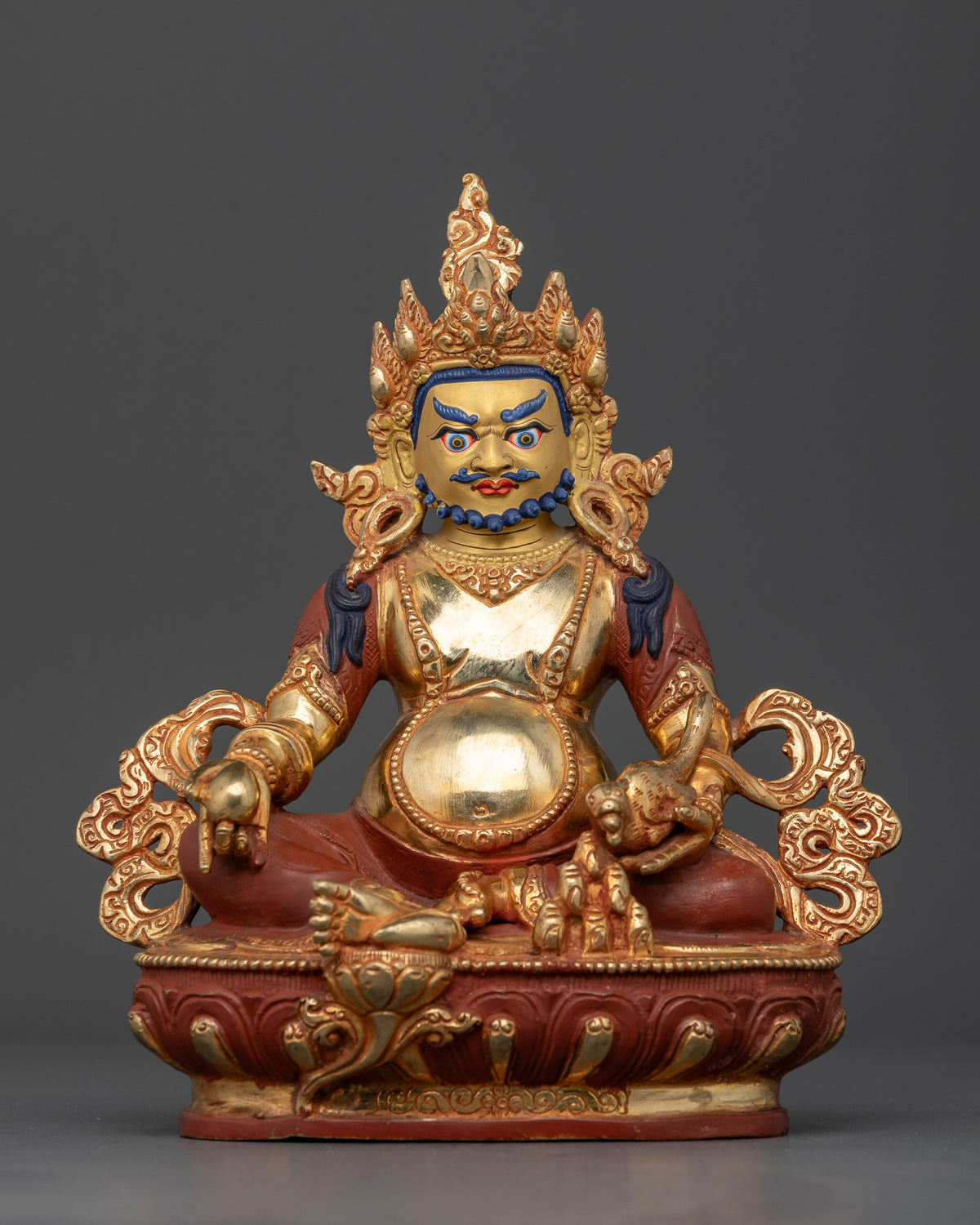 Dzambhala Buddhist wealth deity holding citron fruit and jewel spitting mongoose