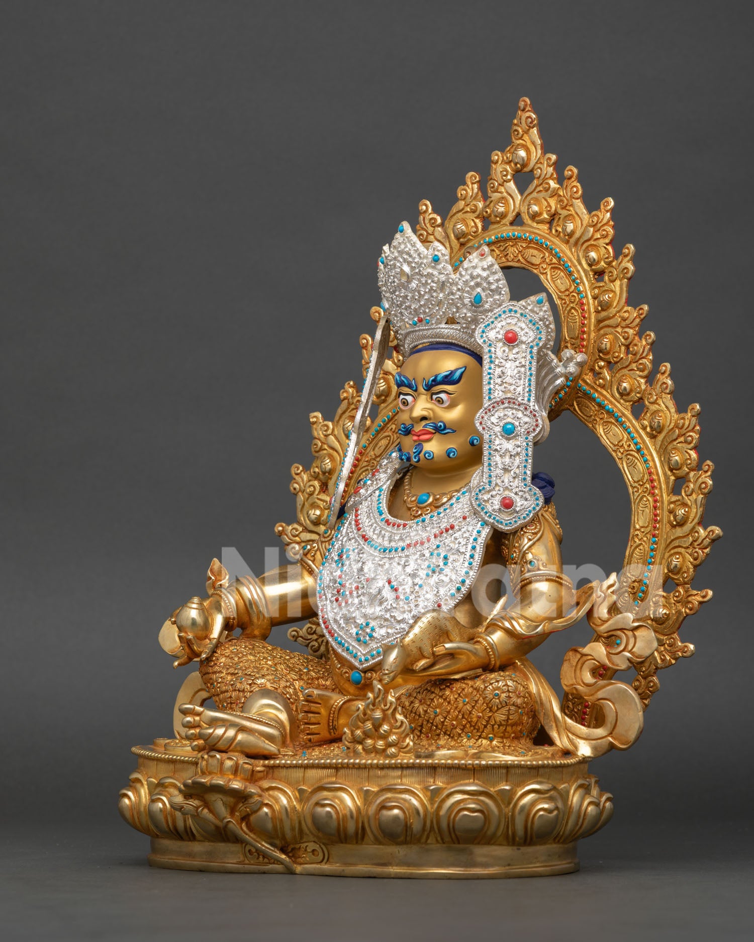 Dzambhala Buddhist wealth deity statue seated on lotus throne with decorated halo and traditional Newari craftsmanship