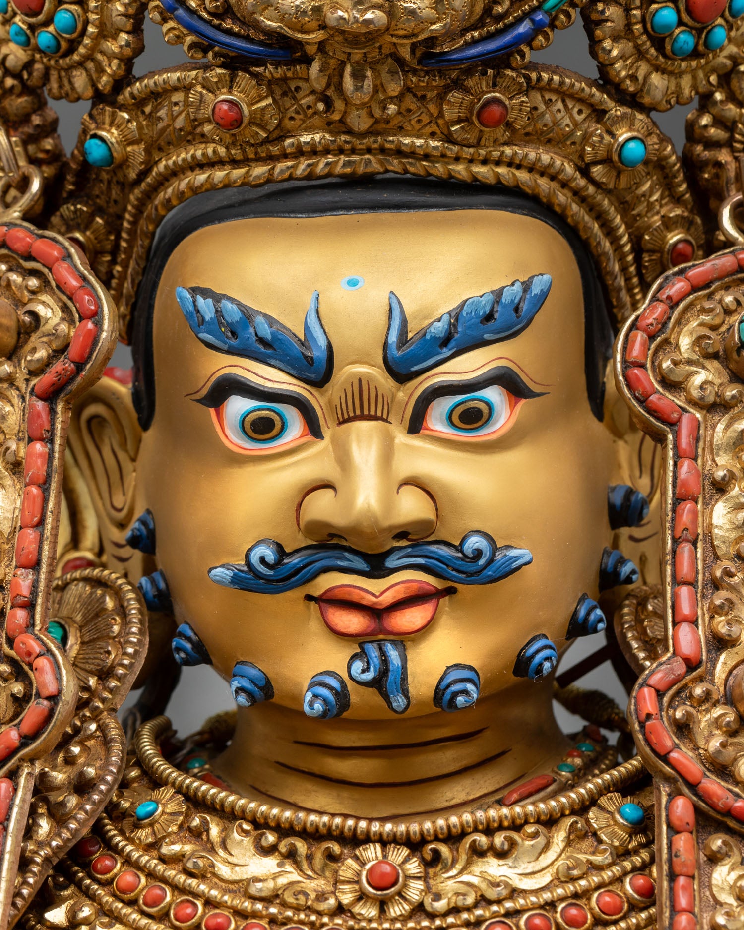 Dzambhala prosperity deity statue in gold-painted face with elaborate ornaments semi-precious stones, Buddhist sacred art sculpture for altar use