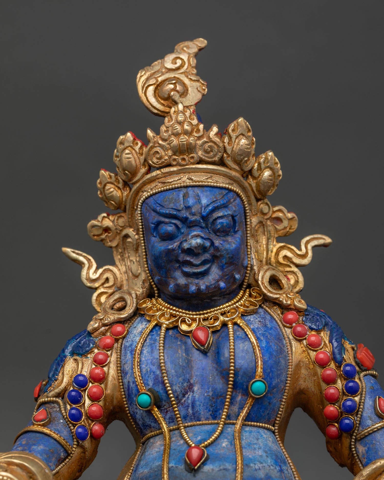 Dzambhala Statue close up view showing coral turquoise inlays and intricate wealth deity ornaments