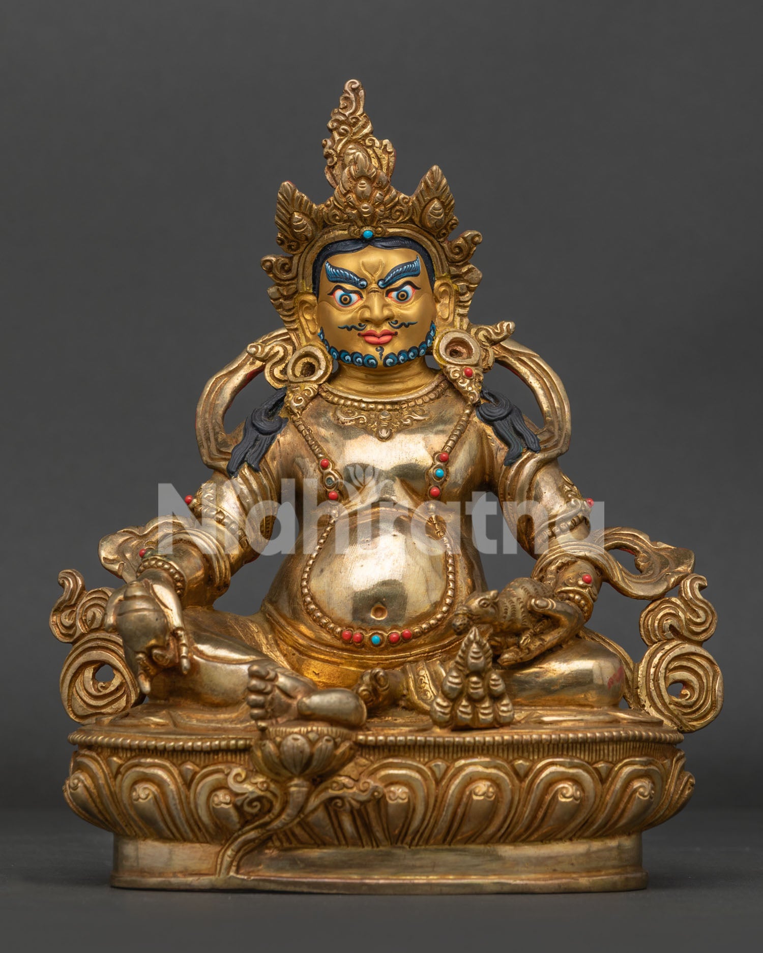 Dzambhala statue from Nepal with gold fire gilding and jeweled lotus pedestal.