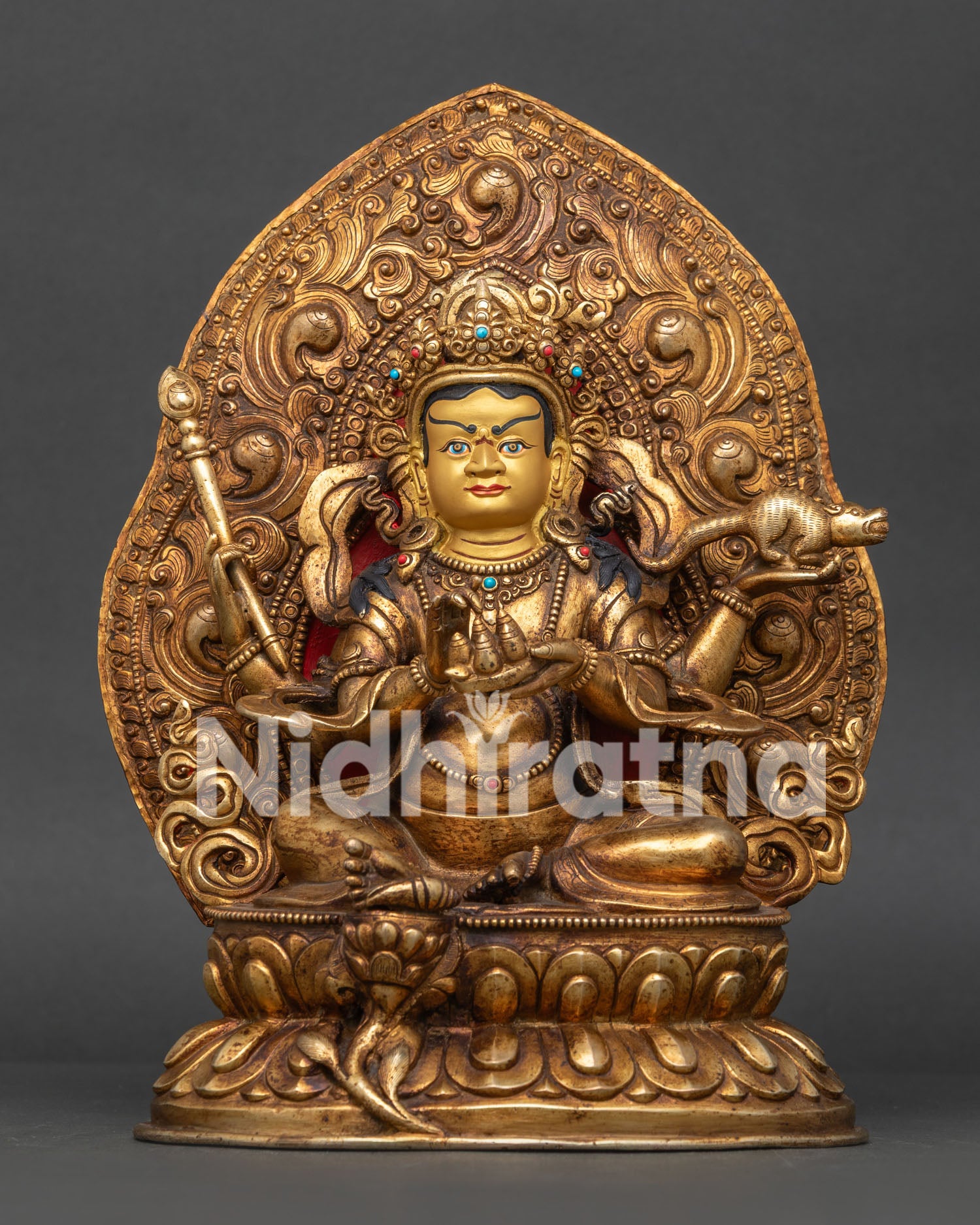 Dzambhala statue front view handcrafted in Patan Nepal with gold fire gilding.