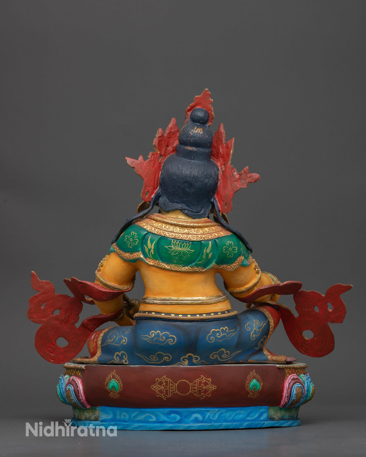 Dzambhala statue multicolor lotus pedestal silk garment citron fruit.