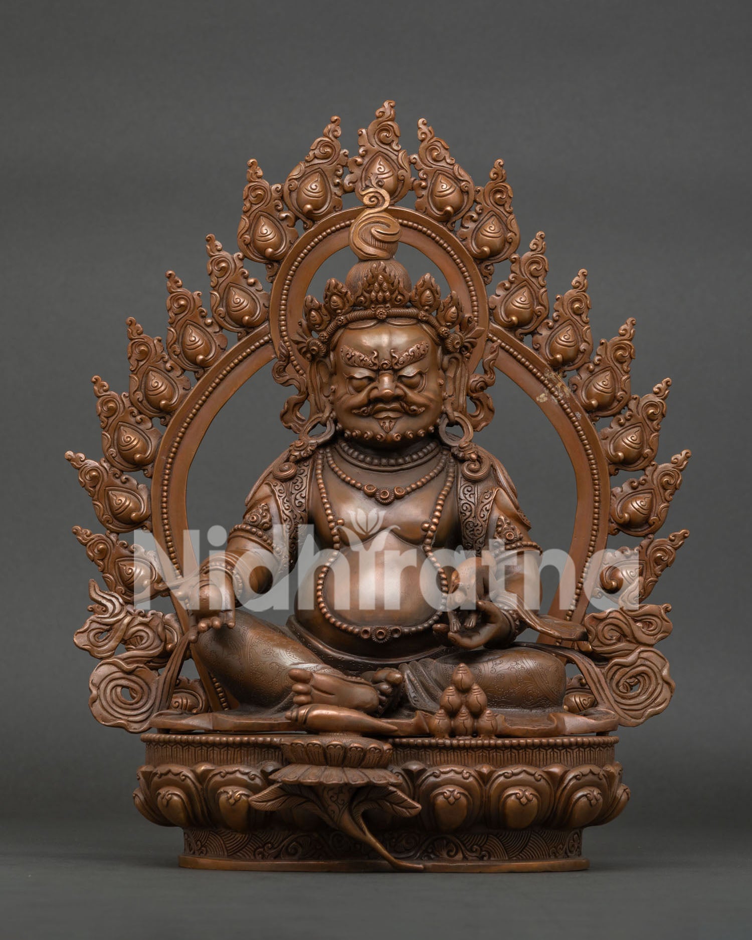 Dzambhala statue with oxidized copper finish and lotus pedestal from Patan, Nepal